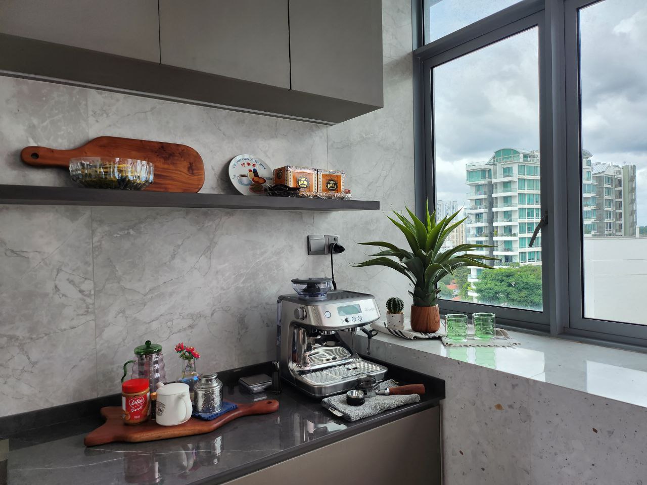 Bright and Airy Modern Home - modern kitchen, marble backsplash, coffee machine, wooden cutting board, spice rack, green