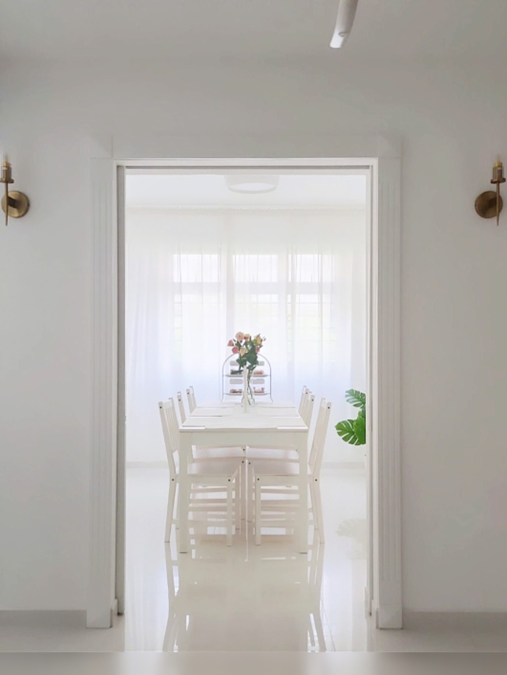 Playroom + Dining room - White dining room, minimalist design, bright ambiance, large windows, sheer curtains, elegant table