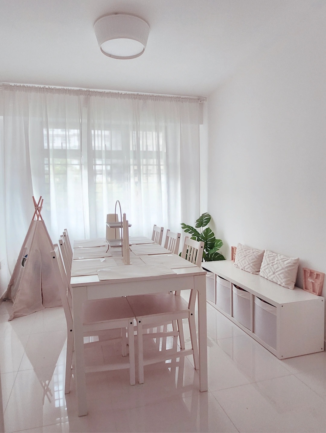 Playroom + Dining room - White dining room, minimalist design, modern furniture, wooden dining table, light-colored chairs