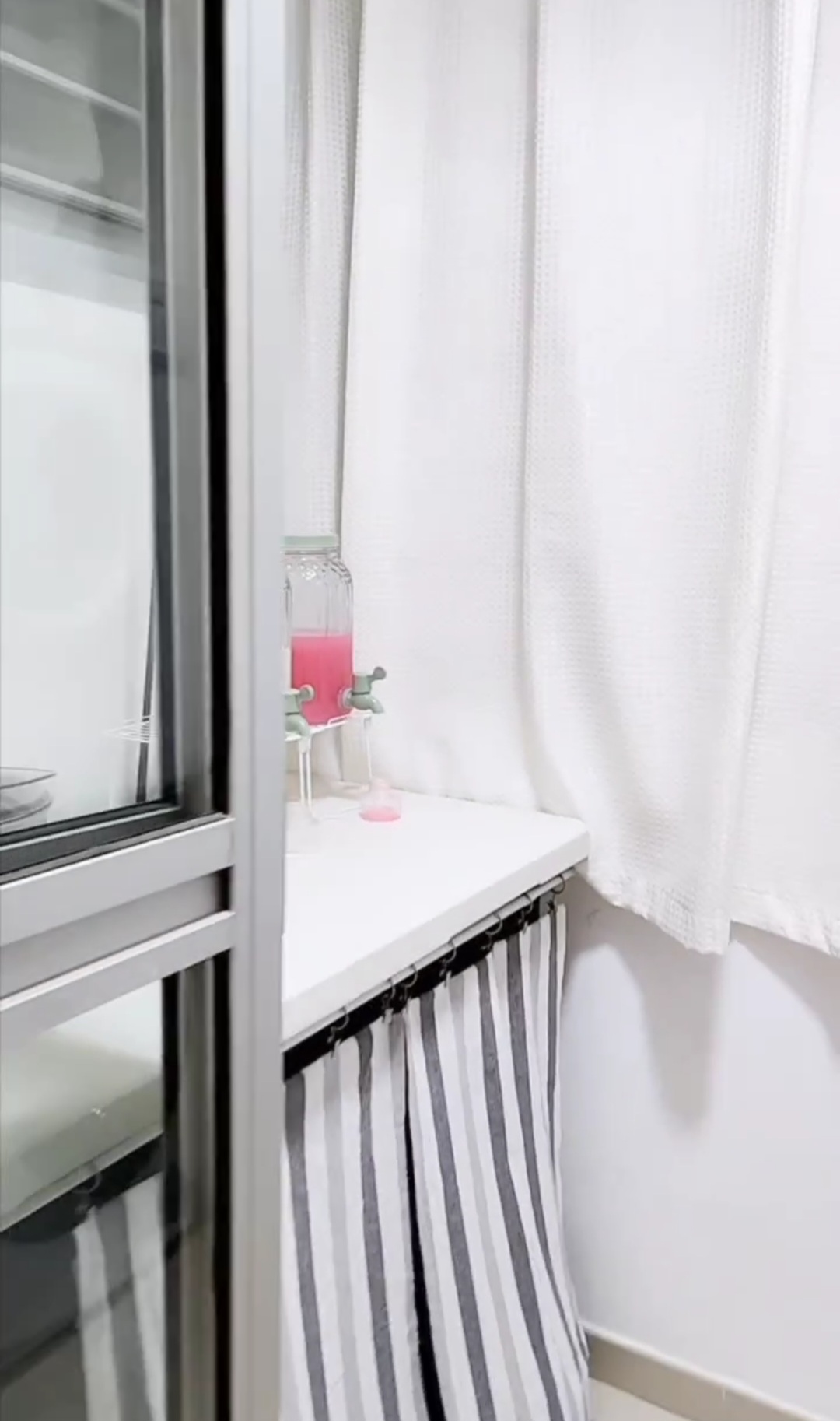 Laundry room of #punggoHField - Glass window, white curtains, striped curtain, pink liquid, glass shelf, white wall, modern