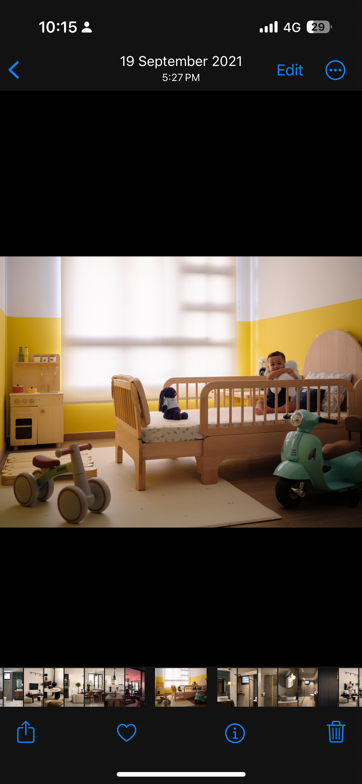 A mid-century modern home in the East - Bright, cheerful room with yellow and white walls, Baby sitting in a wooden crib