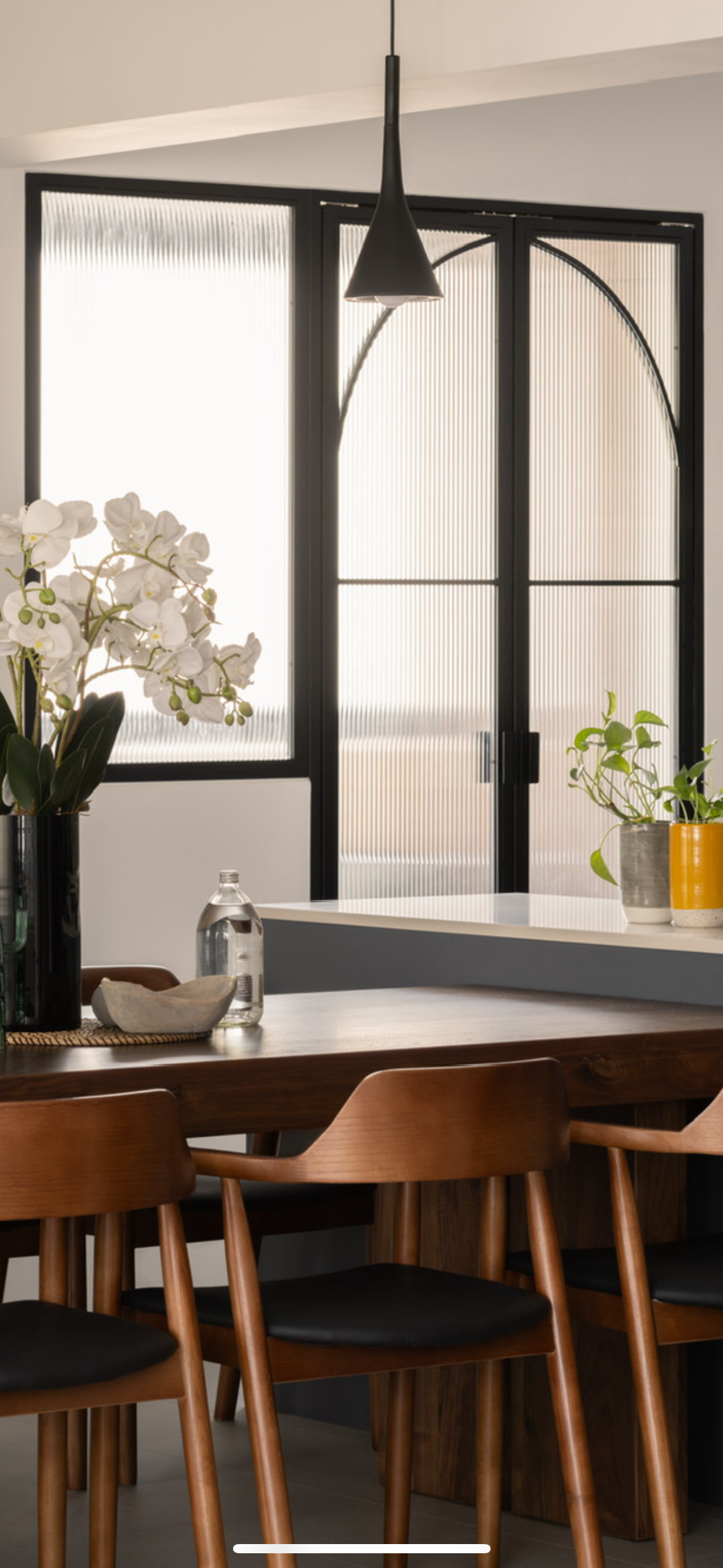 A mid-century modern home in the East - Modern dining room, minimalist design, large windows, black frame, white orchids
