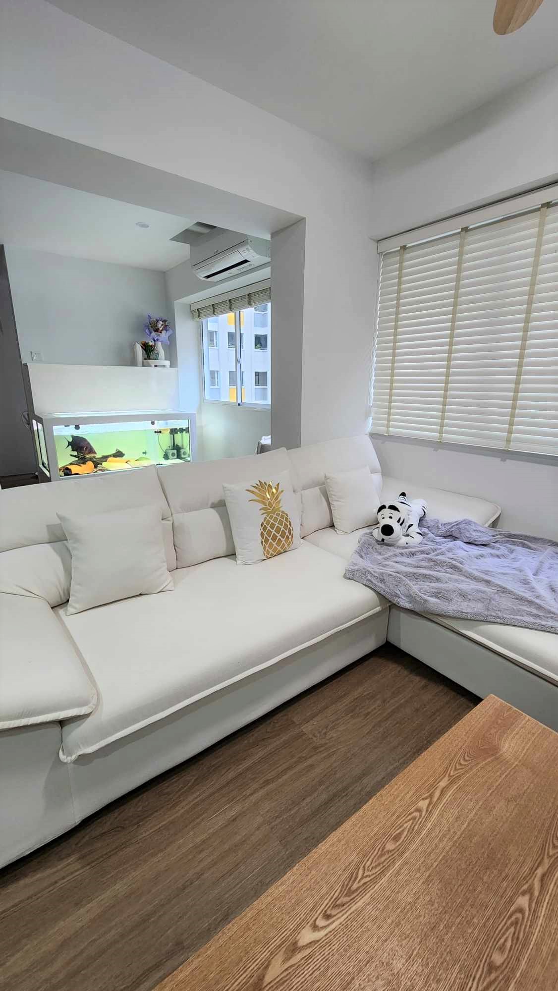 Our little cozy space in the home  - White modern living room with minimalist decor, white sectional sofa, gold pineapple