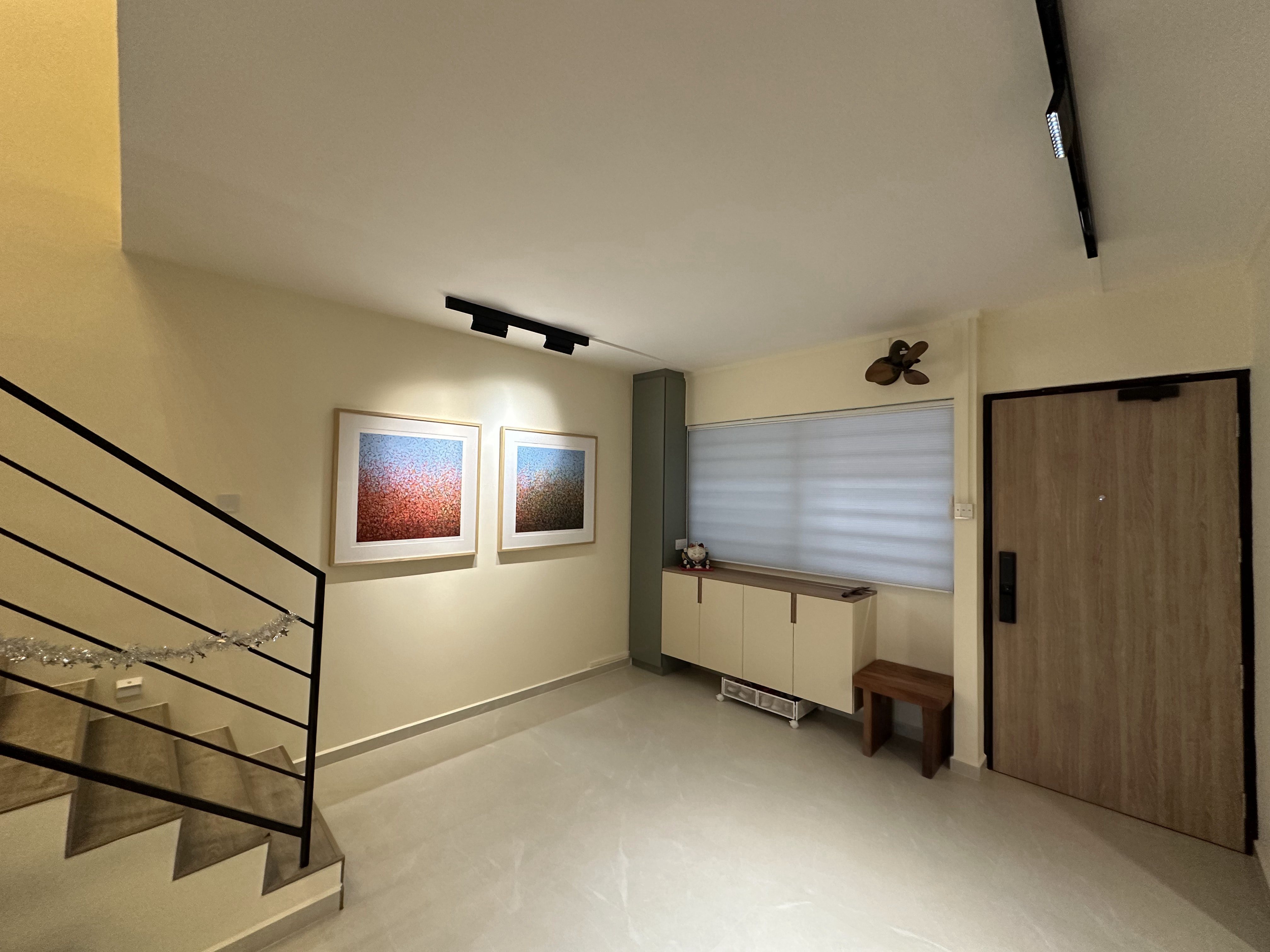 Warm Japandi vibes of a 30 year old Maisonette - Modern minimalist interior, abstract art on wall, staircase with black