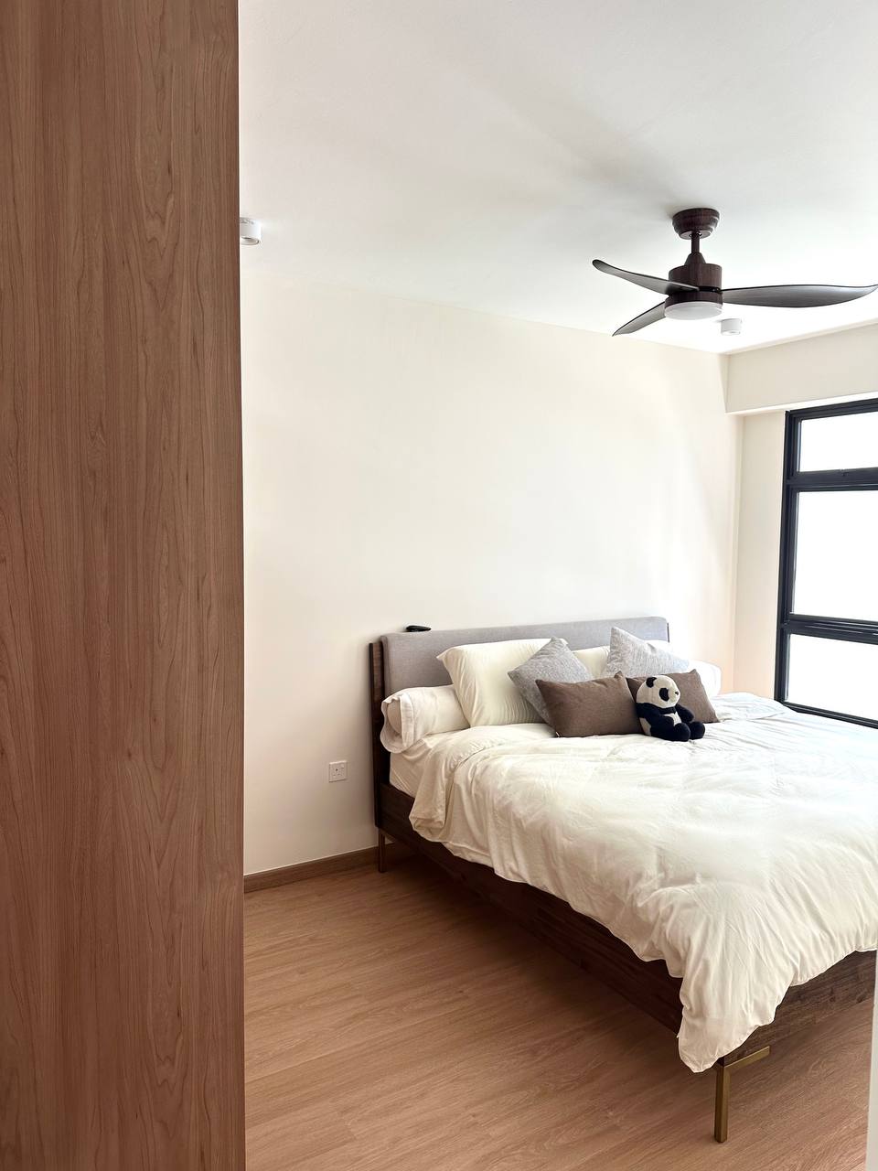 A self-designed flat with lots of neutrals & wood - Wooden floor, wooden door, white walls, ceiling fan, beige bedding, gray