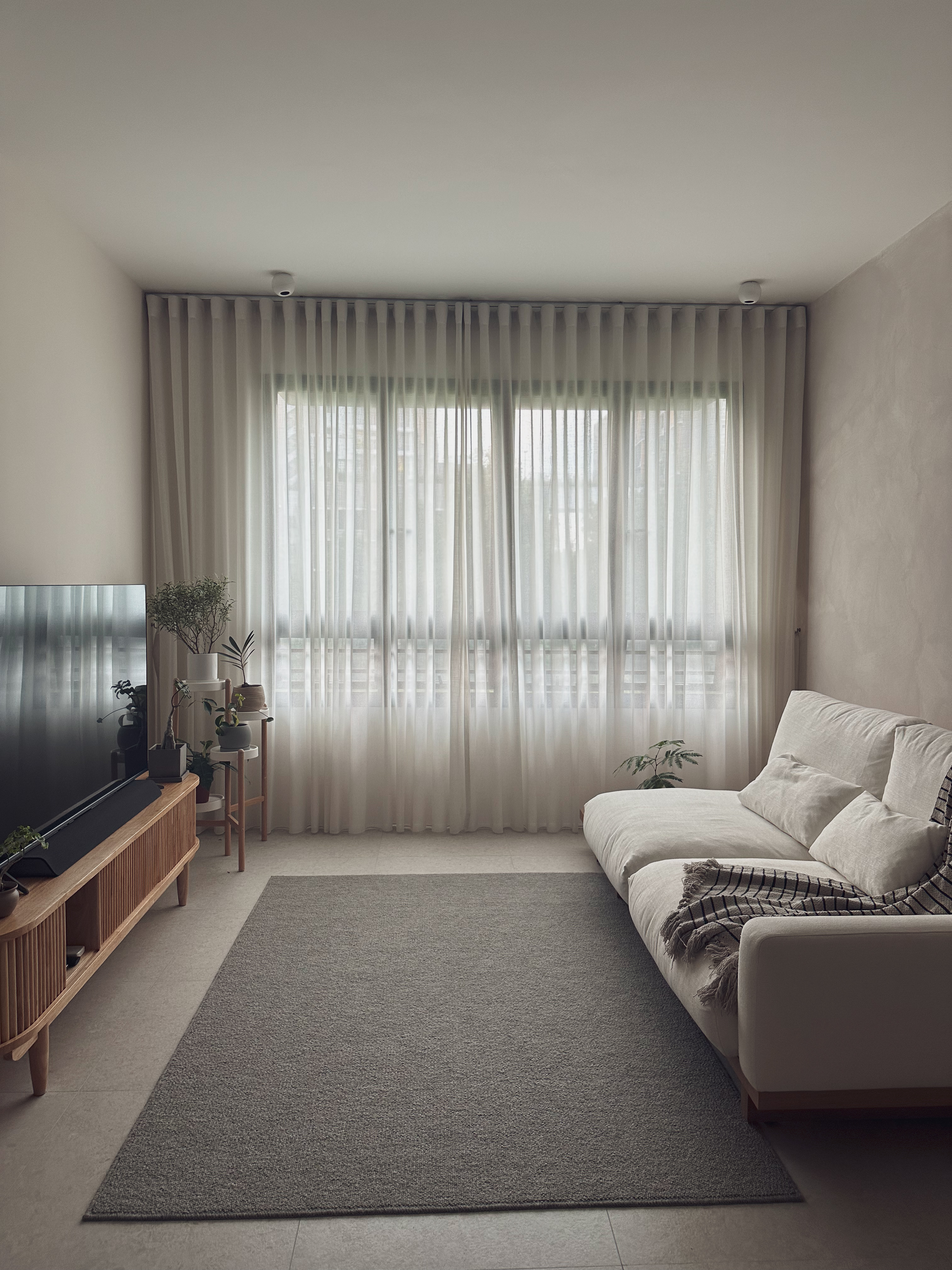 Japandi and Wabi-sabi inspired home of jco - Modern living room, minimalist decor, neutral color palette, large window, sheer