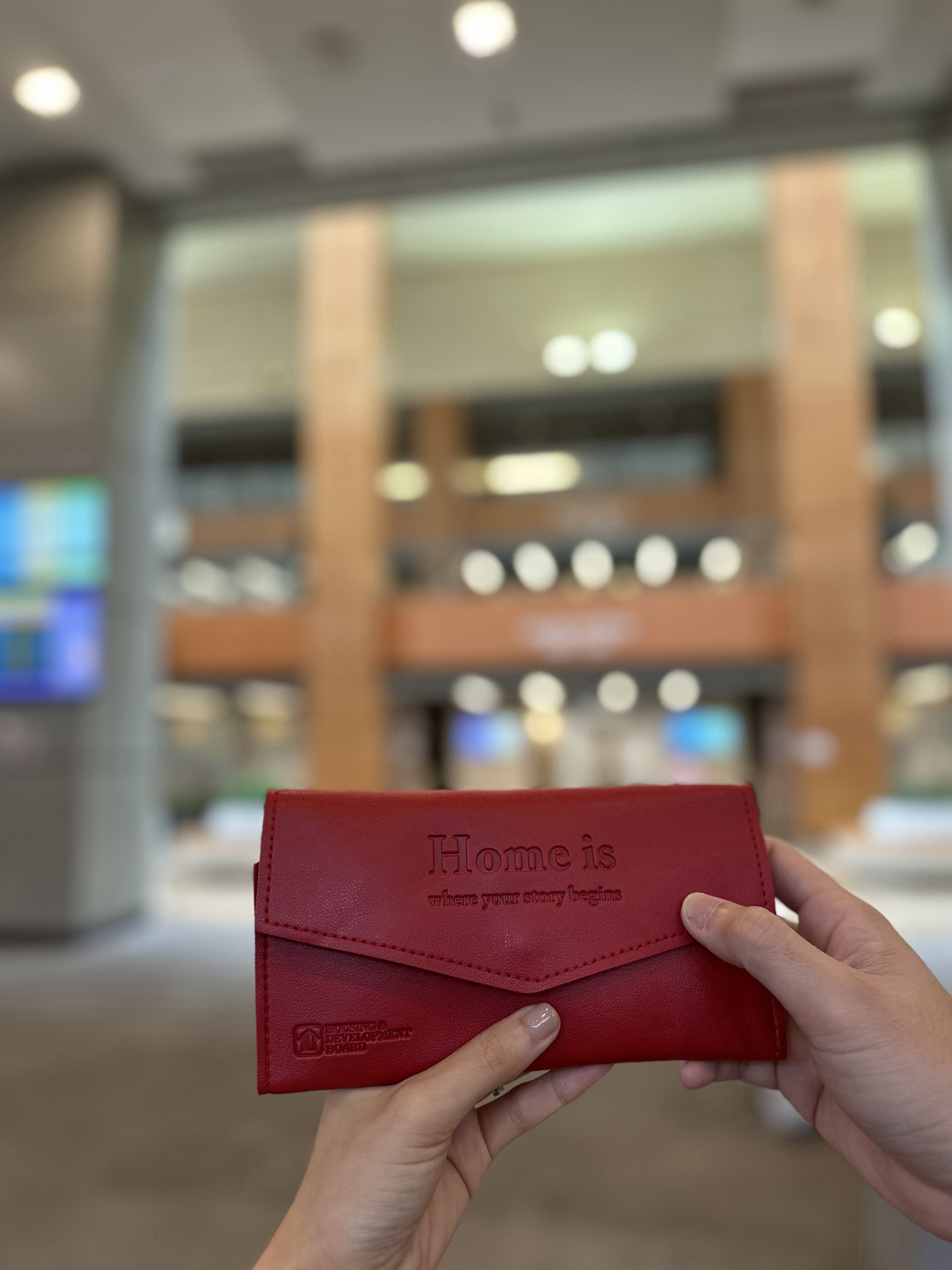 Japandi and Wabi-sabi inspired home of jco - Red leather wallet, "Home is where your story begins, " embossed text, person's