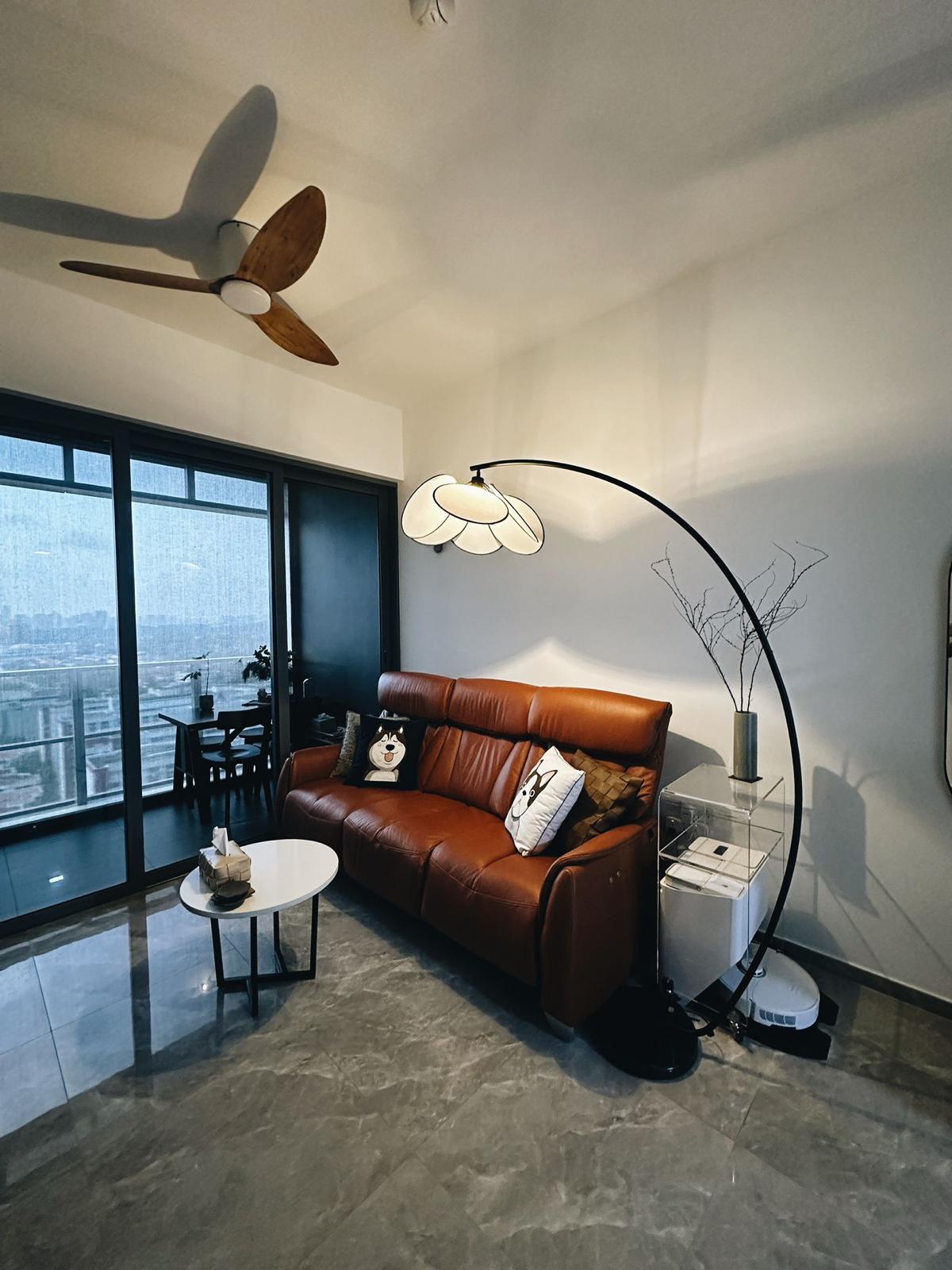 Smol Home best suits for singles & couples - Modern living room with large windows, brown leather sofa, decorative pillows