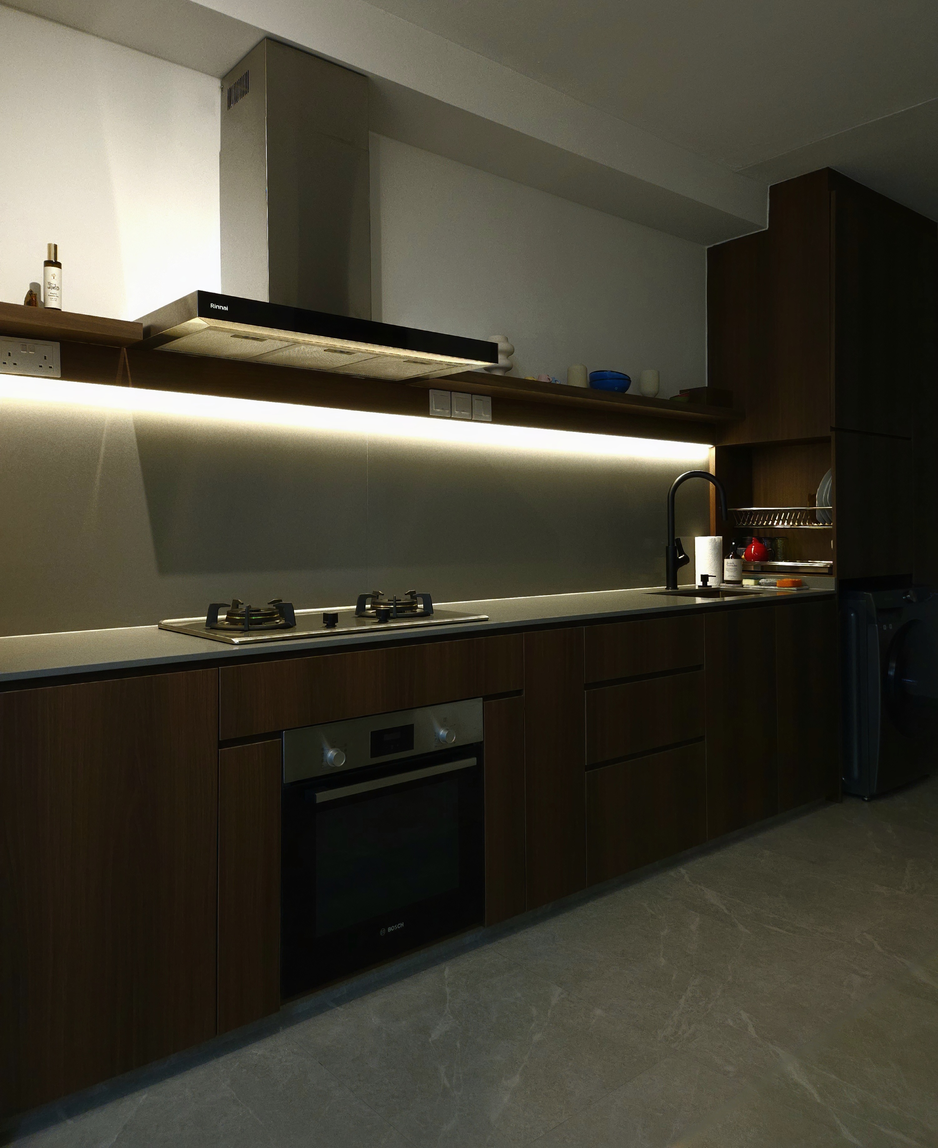 The theme-less abode - Modern kitchen with sleek design, stainless steel appliances, dark wood cabinetry, under-cabinet