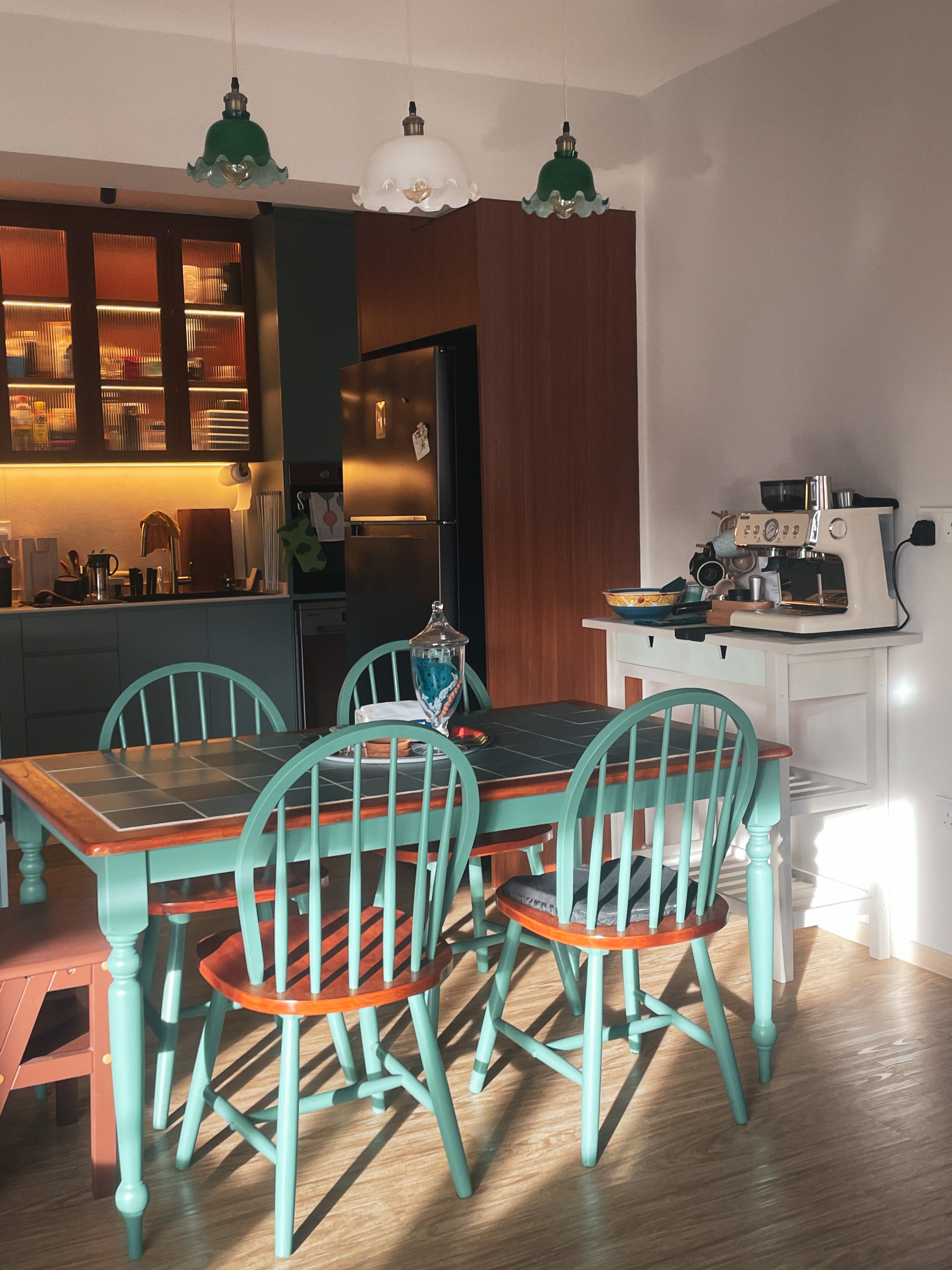 A refurbished home full of personality - Turquoise dining table with wooden legs, surrounded by four chairs, floor tiles