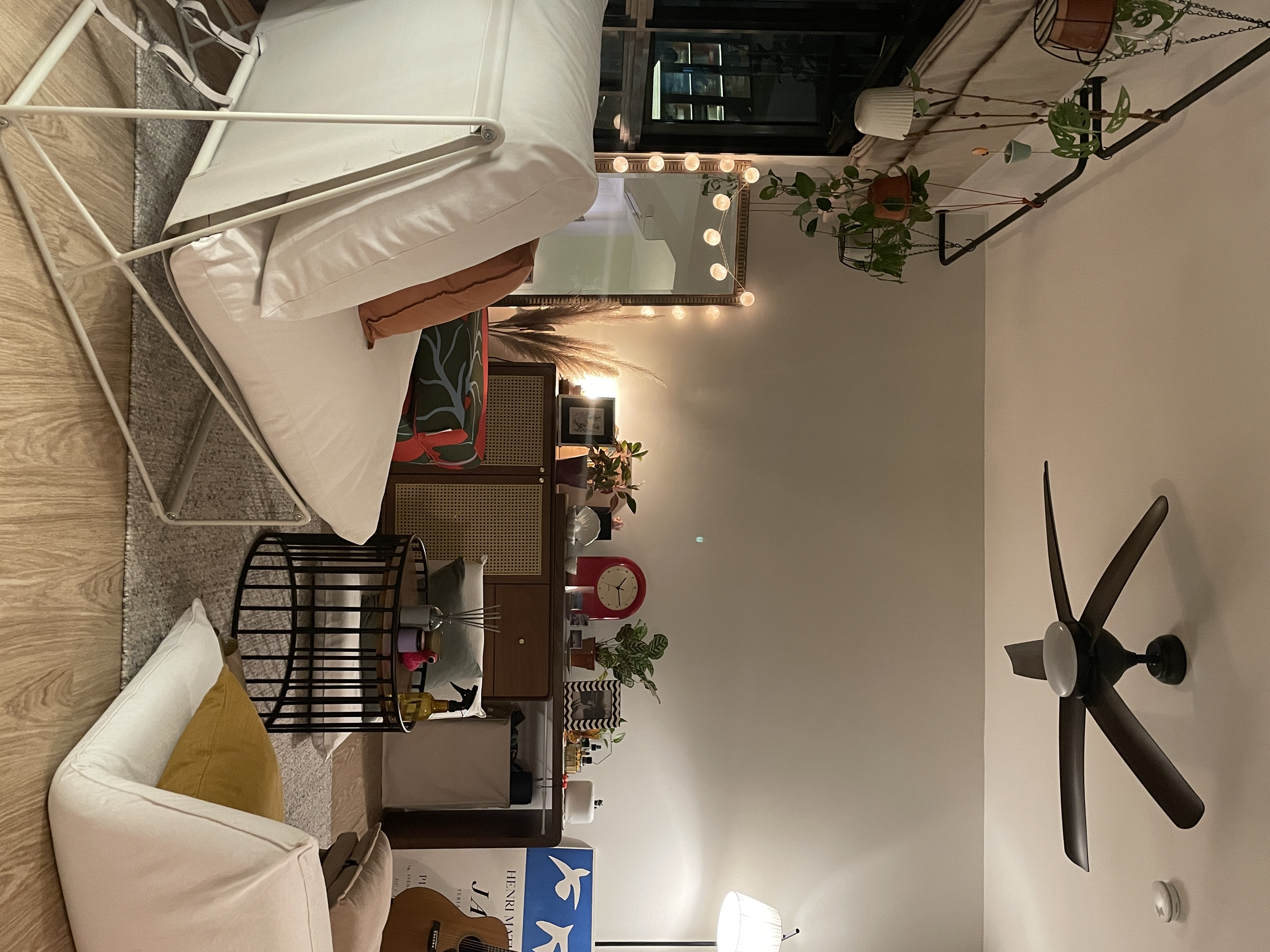 A refurbished home full of personality - modern living room, cozy seating, white sofa, brown accent chair, floor lamp