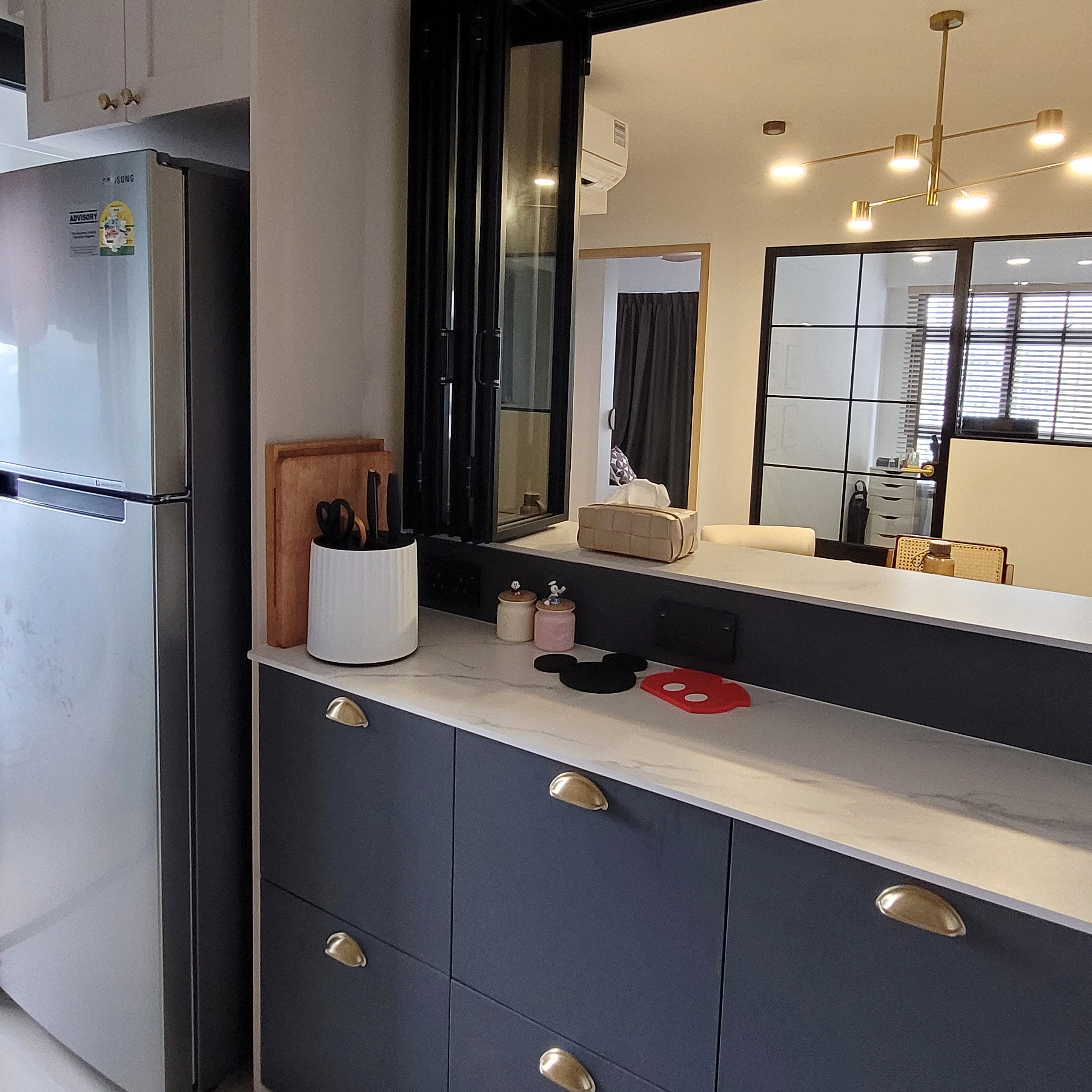 Step into our Modern Farmhouse with pops of Disney - Modern kitchen with sleek design, stainless steel refrigerator, dark