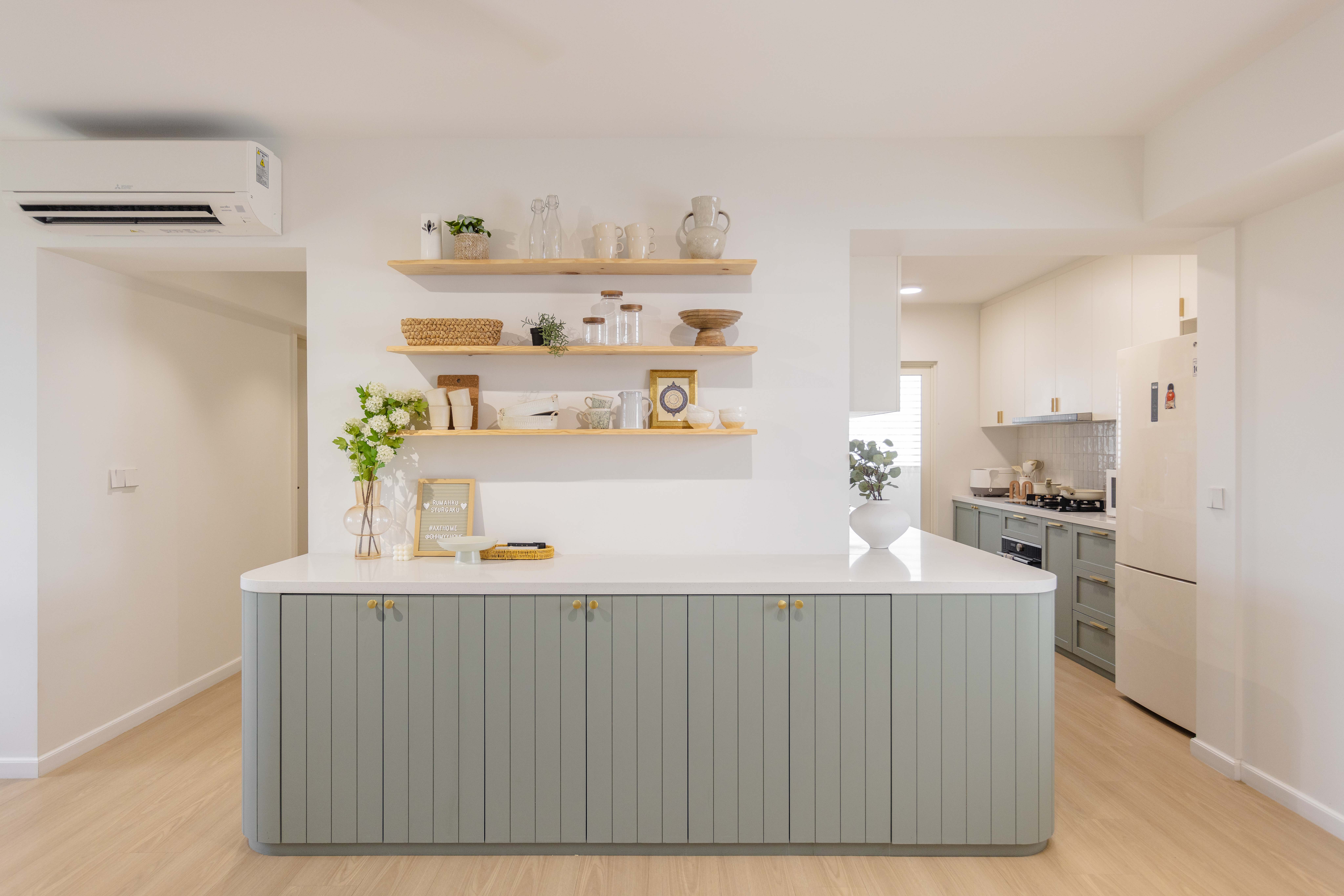 Bright, Airy & Curvy! - Modern kitchen with light grey cabinets and white countertops, air conditioning unit above