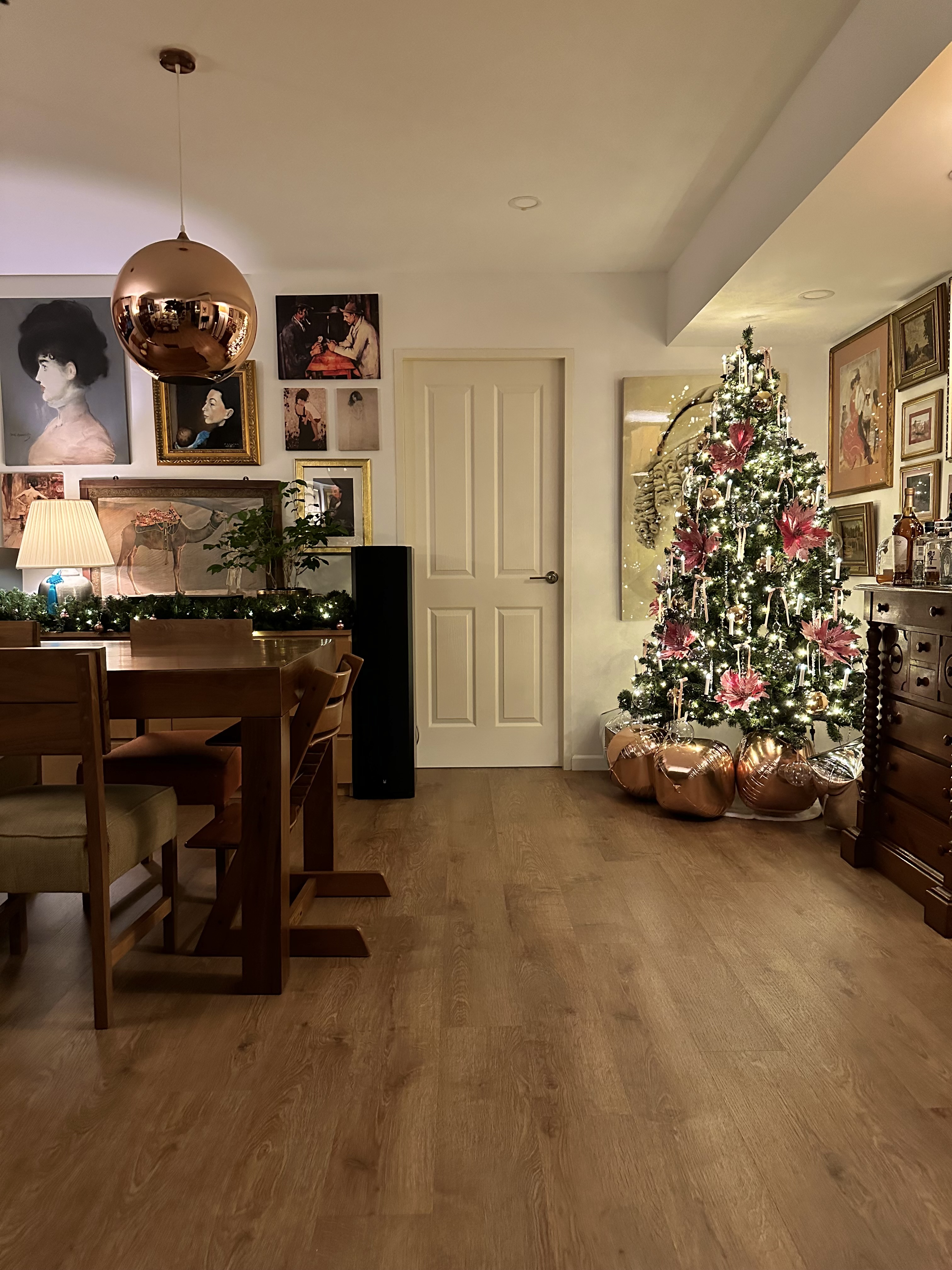 Our Home's Holiday Glow-Up with Crystal Sparkles and Pretty in Pink - Modern dining room, cozy ambiance, wooden floor