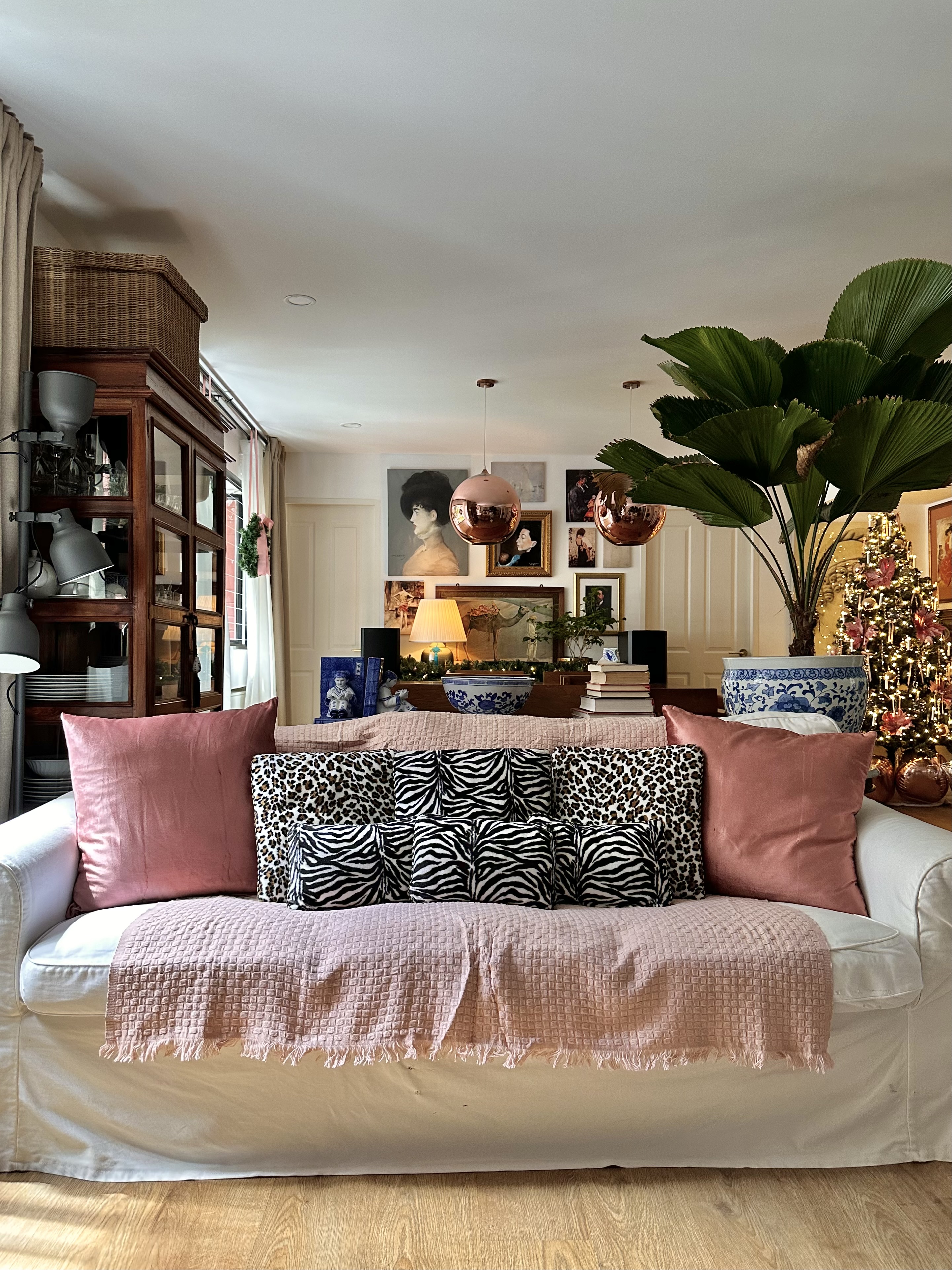 Our Home's Holiday Glow-Up with Crystal Sparkles and Pretty in Pink - White sofa with pink and leopard print pillows