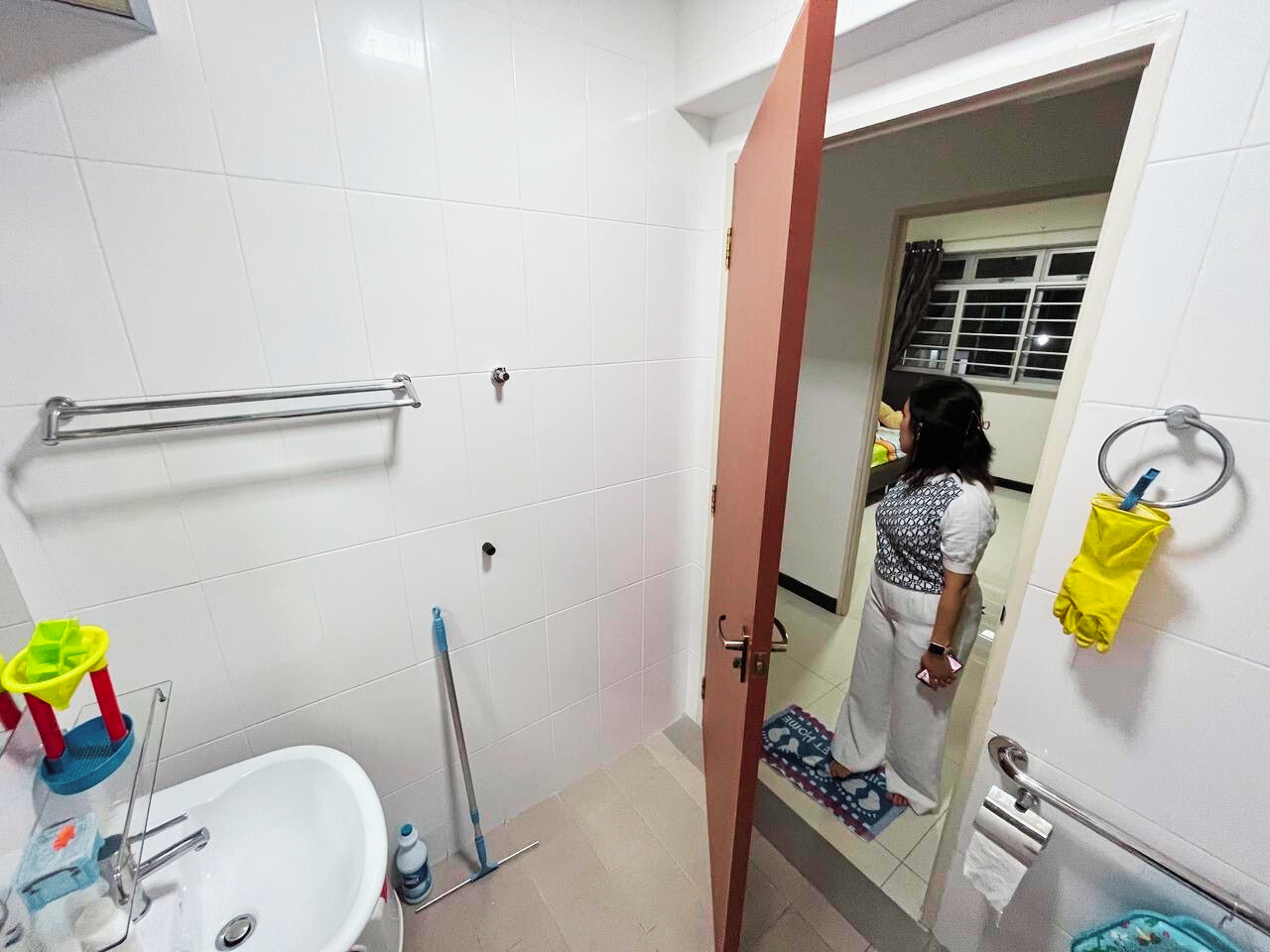 Transforming our HDB flat to a Filipino-inspired Villa Home - White tiled bathroom, woman standing, bathroom door open