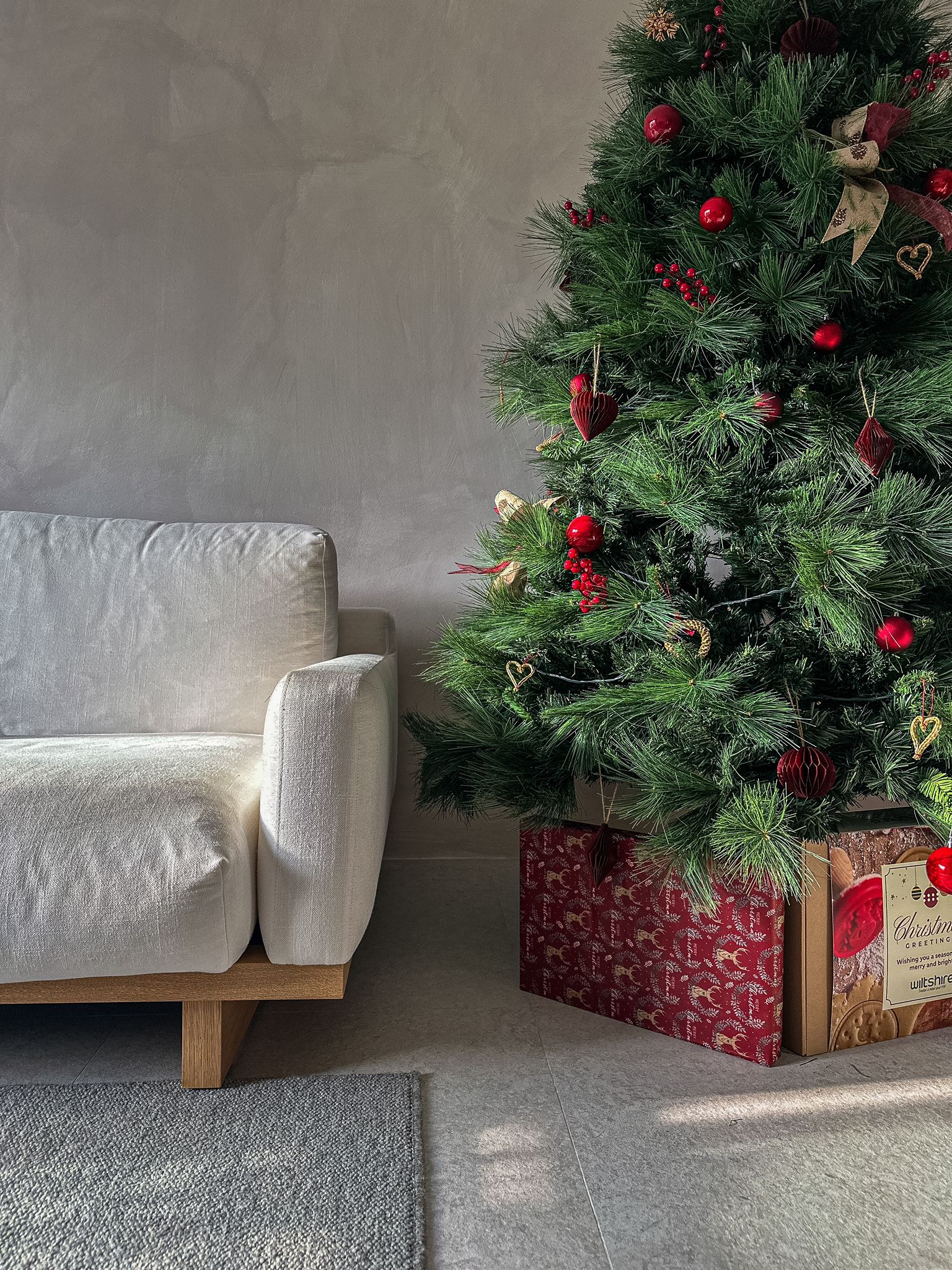 Bringing our Japandi theme to life - Christmas tree, festive decorations, red ornaments, green needles, cozy room, soft