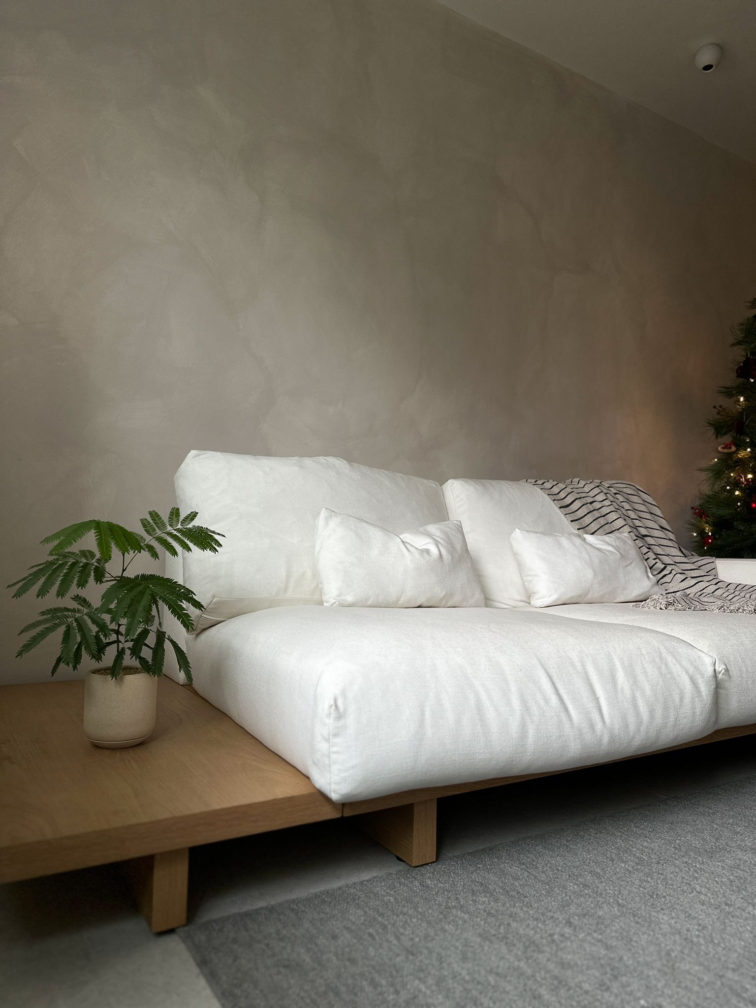 Bringing our Japandi theme to life - White sofa, minimalist decor, cozy atmosphere, modern interior, soft lighting, neutral