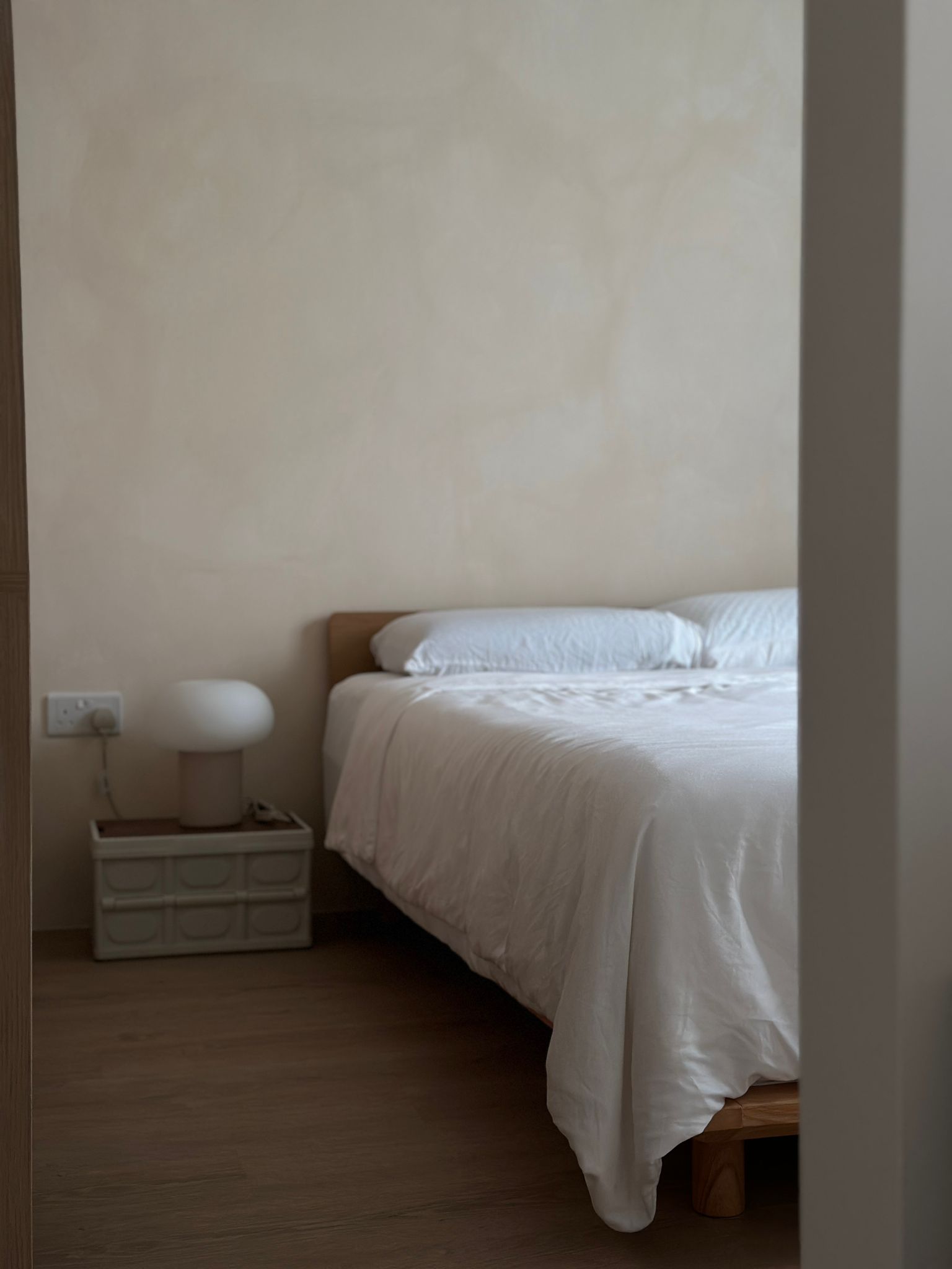 Bringing our Japandi theme to life - Minimalist bedroom, cozy bed, white bedding, wooden floor, bedside table, modern lamp