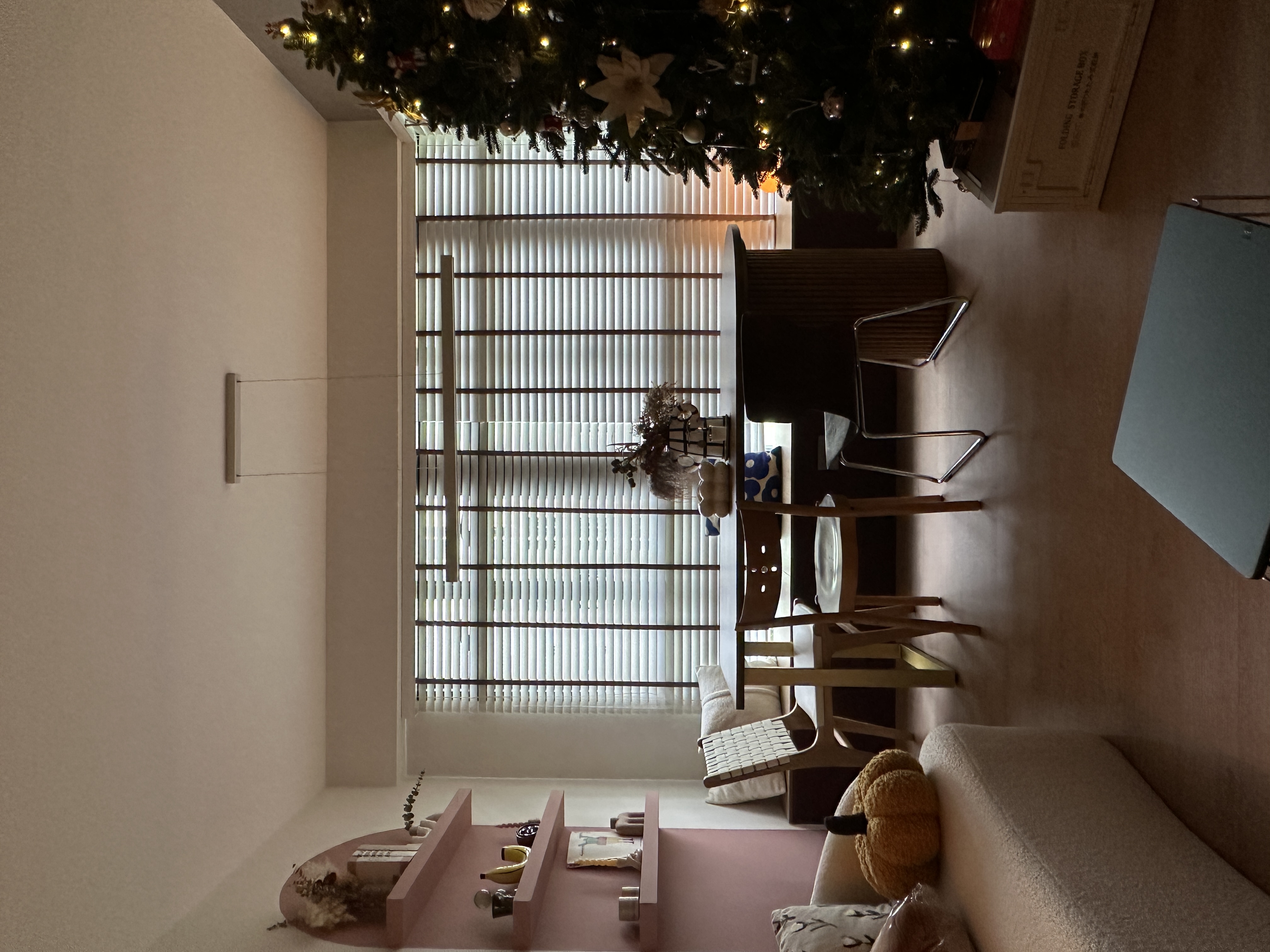 A cozy dining space right at the window bay!  - Christmas tree adorned with lights and ornaments, large window with blinds