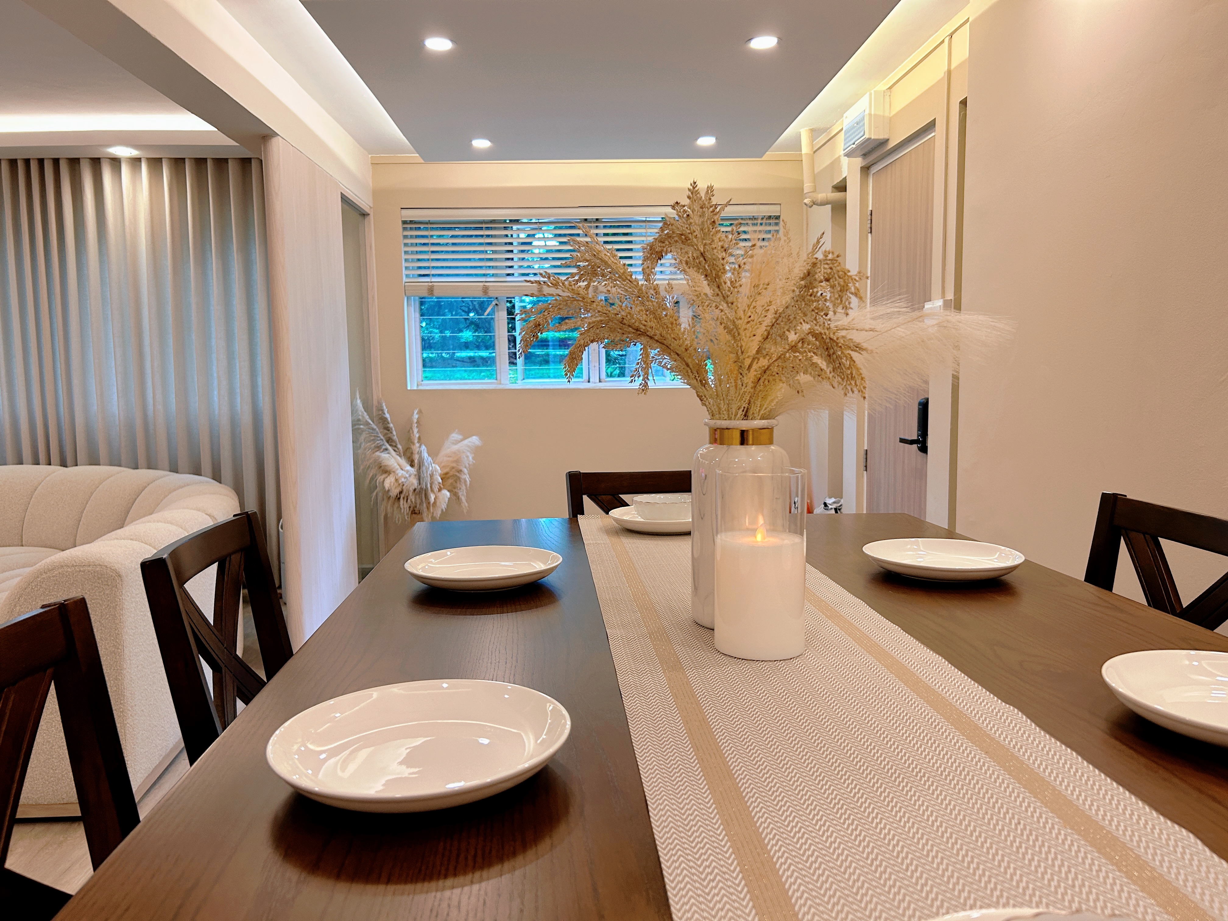 Our inviting dining space! - Modern dining room with minimalist design, wooden dining table, white plates, beige textured