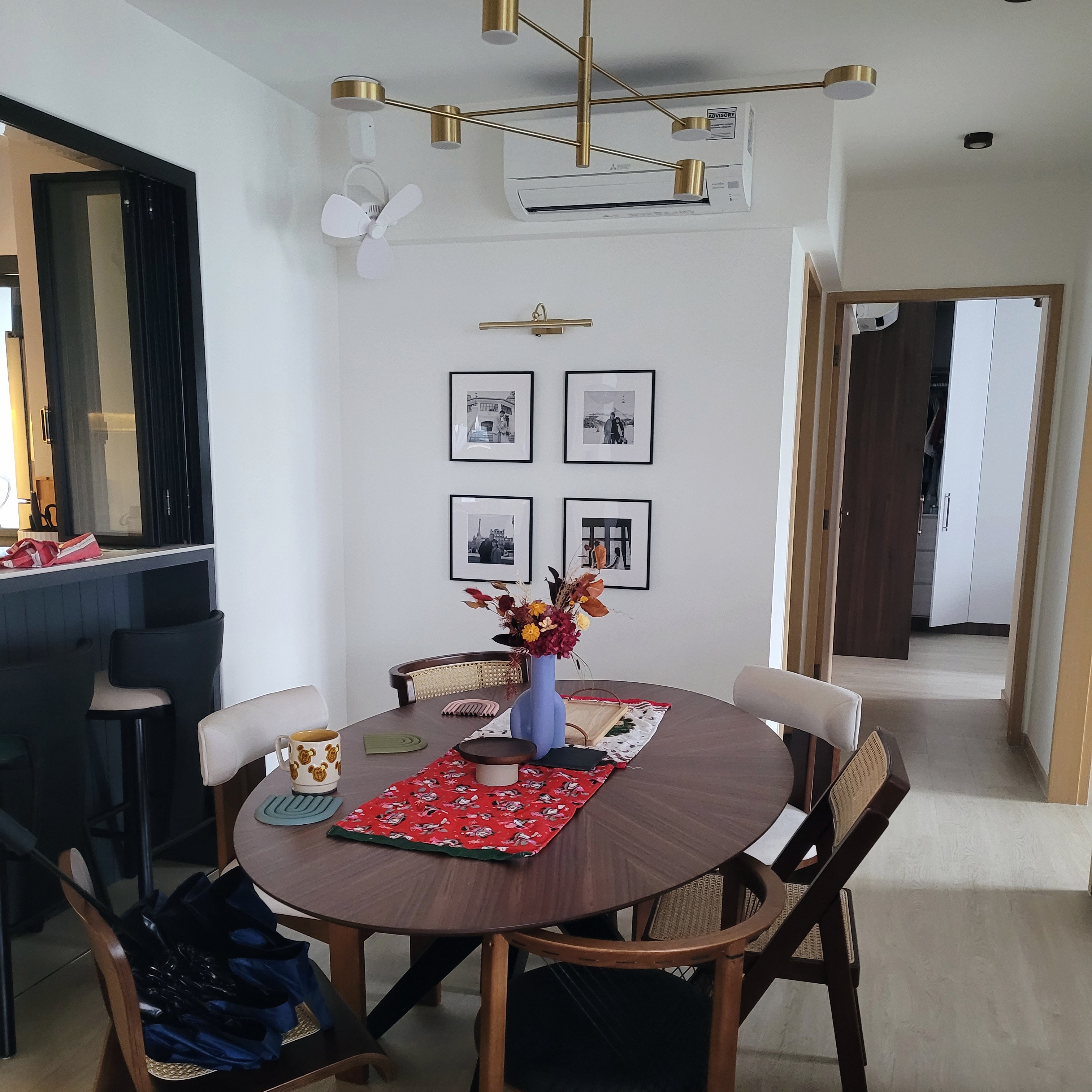 Heart of the home: Dining Space - Modern dining room with round wooden table, blue vase with autumn flowers, red tablecloth
