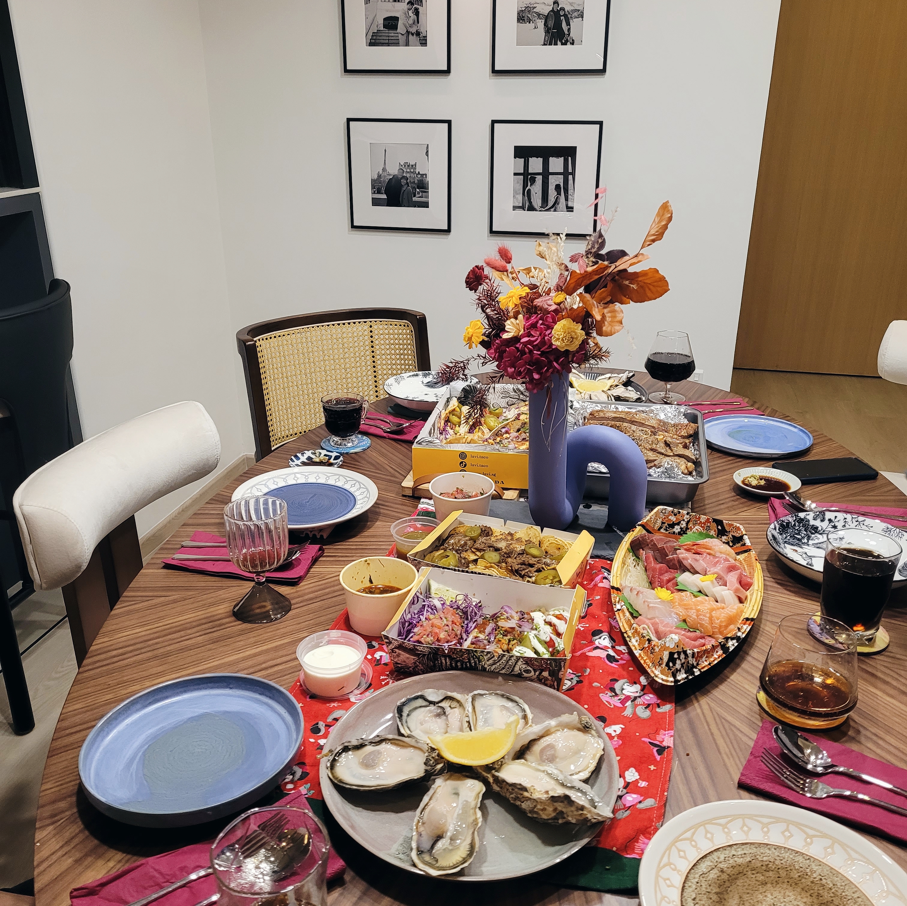 Heart of the home: Dining Space - wooden dining table, family dinner, colorful plates, seafood platter, oysters, salad, wine