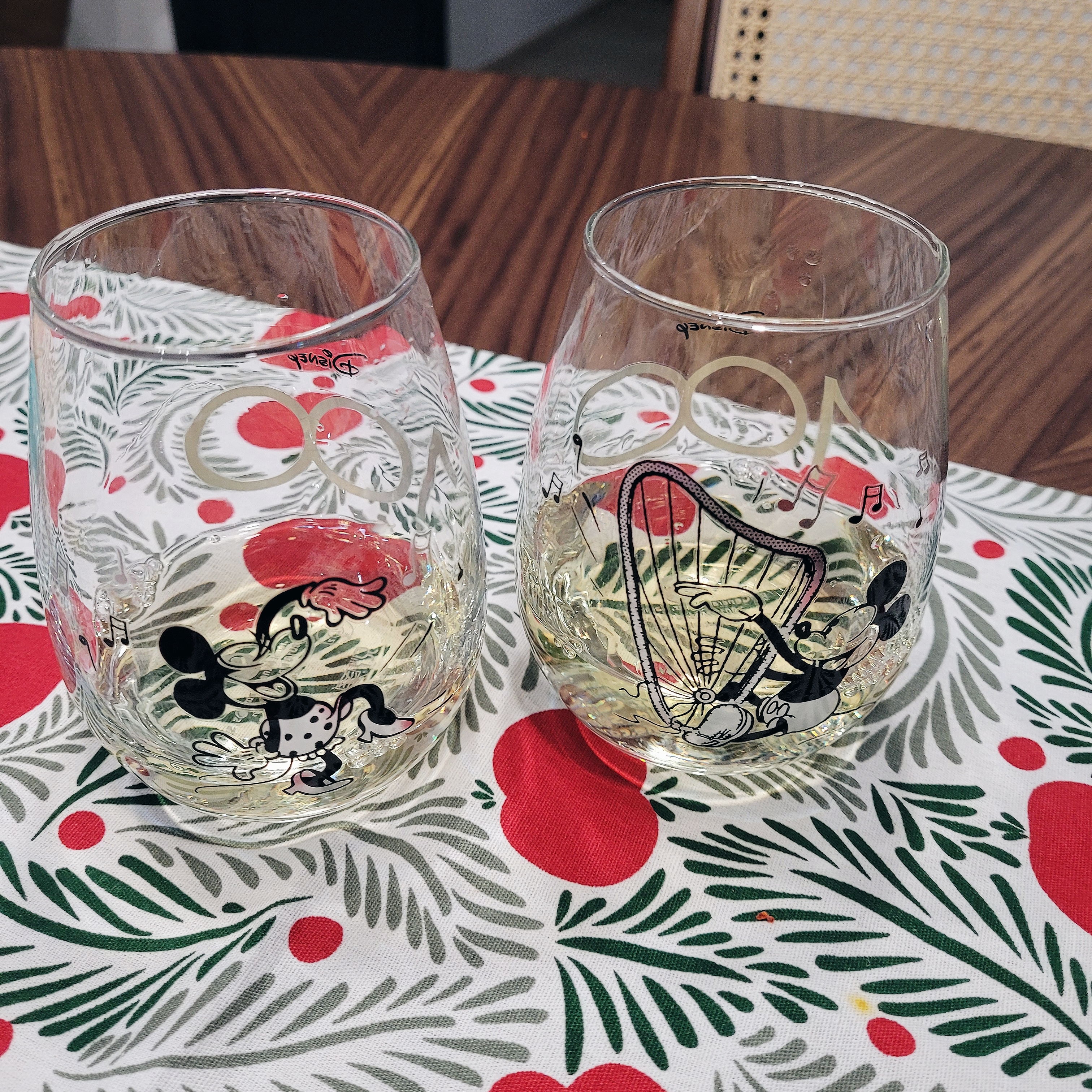 Heart of the home: Dining Space - Clear glass, Mickey Mouse design, festive tablecloth, red and green leaves, holiday theme