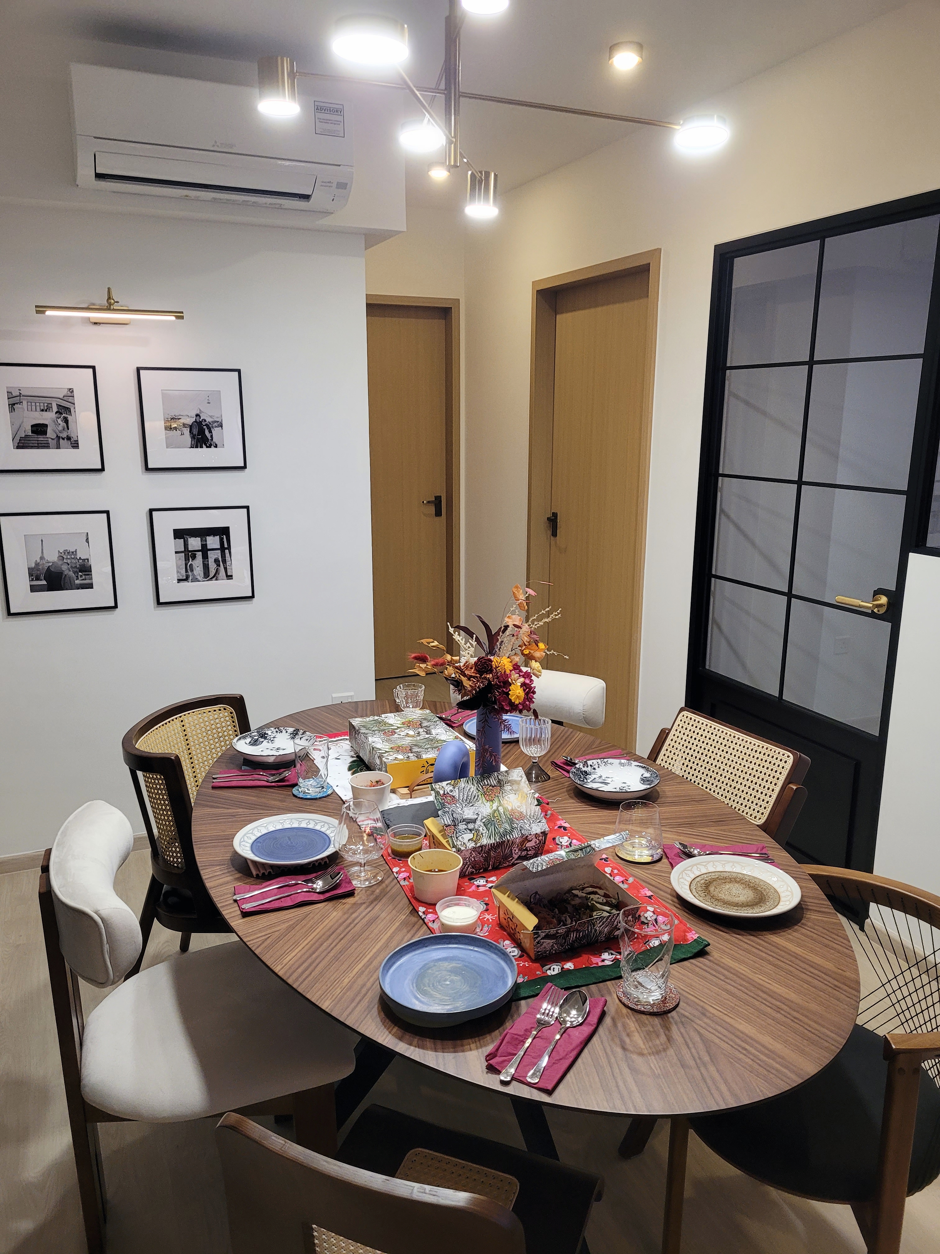 Heart of the home: Dining Space - Modern dining room, round wooden table, elegant table setting, black and white photographs