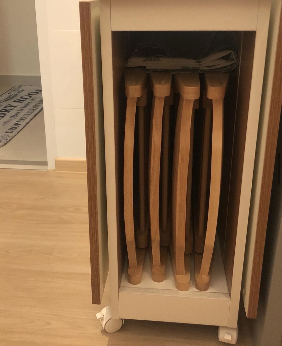 Our Dining Space: 2 Dining Zones for Maximum Flexibility - Wooden rolling kitchen utensils neatly stored in a cabinet, light