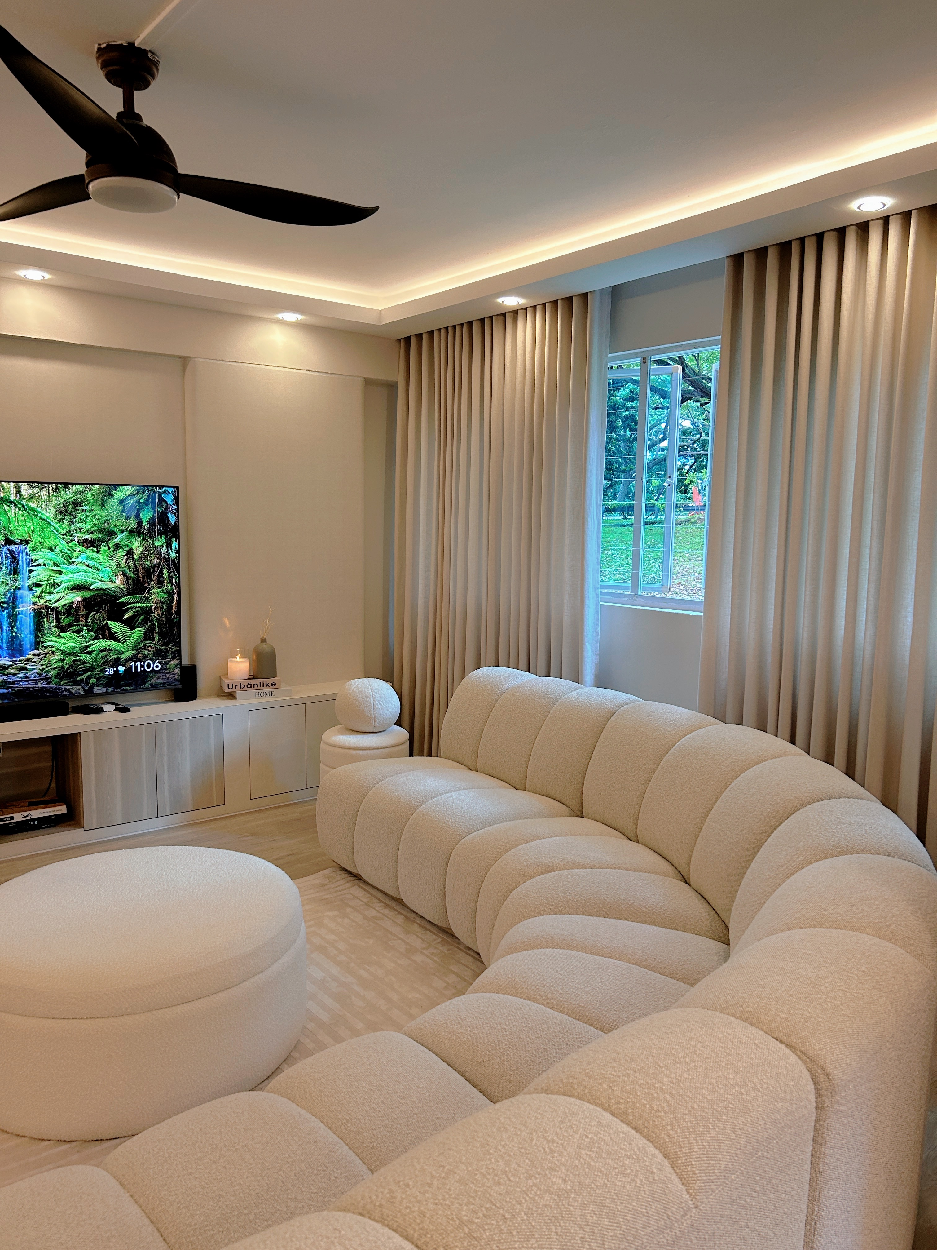 Welcome to Marshy Home! - Modern living room with beige sectional sofa, large flat-screen TV, recessed ceiling lights