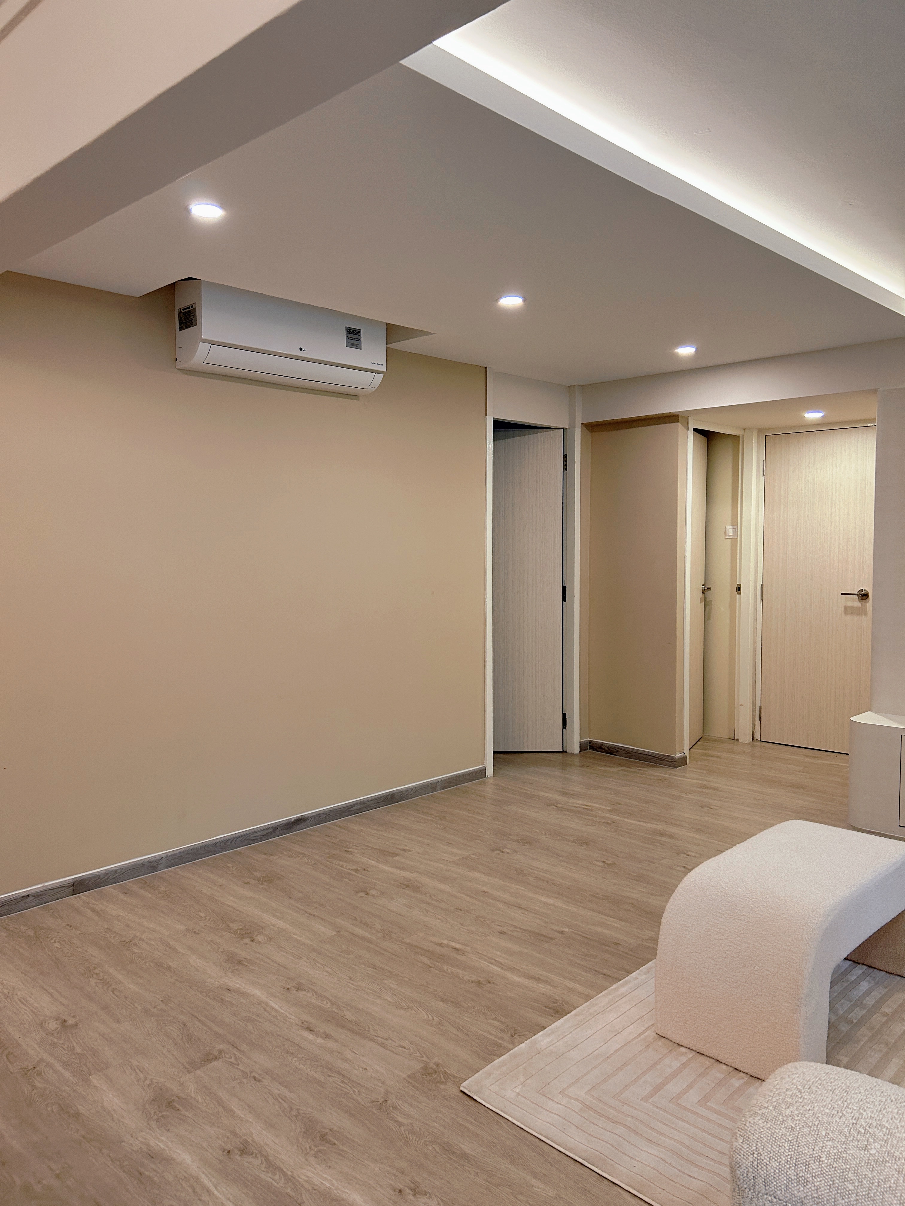 Welcome to Marshy Home! - Modern minimalist living room, neutral color palette, beige walls, recessed ceiling lights, air