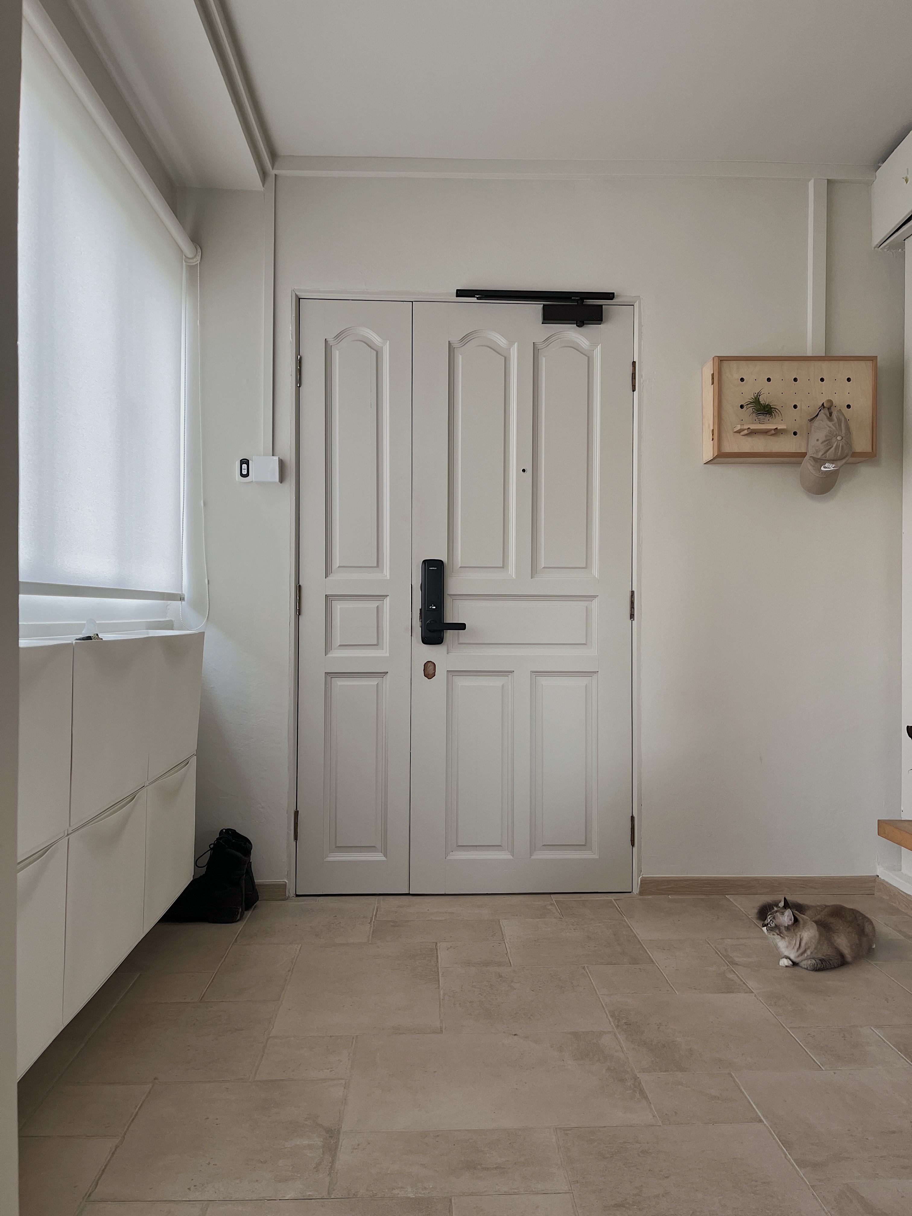 A calm and cosy space - White paneled door, minimalist design, modern aesthetic, light gray walls, tiled floor, cozy room