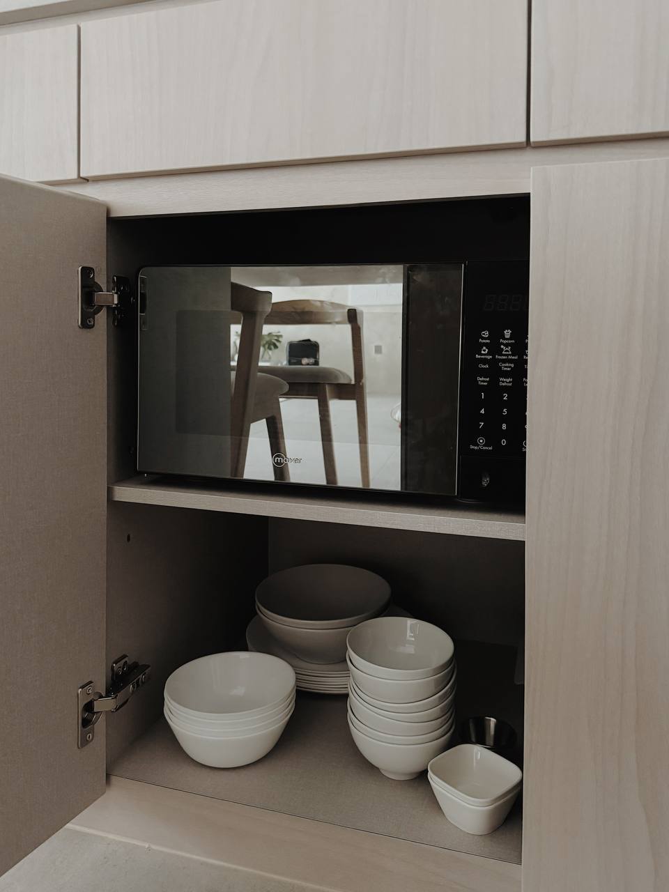 Dining Space: Making every Meal a Communal Experience - microwave, kitchen cabinets, open microwave, white bowls, stacked