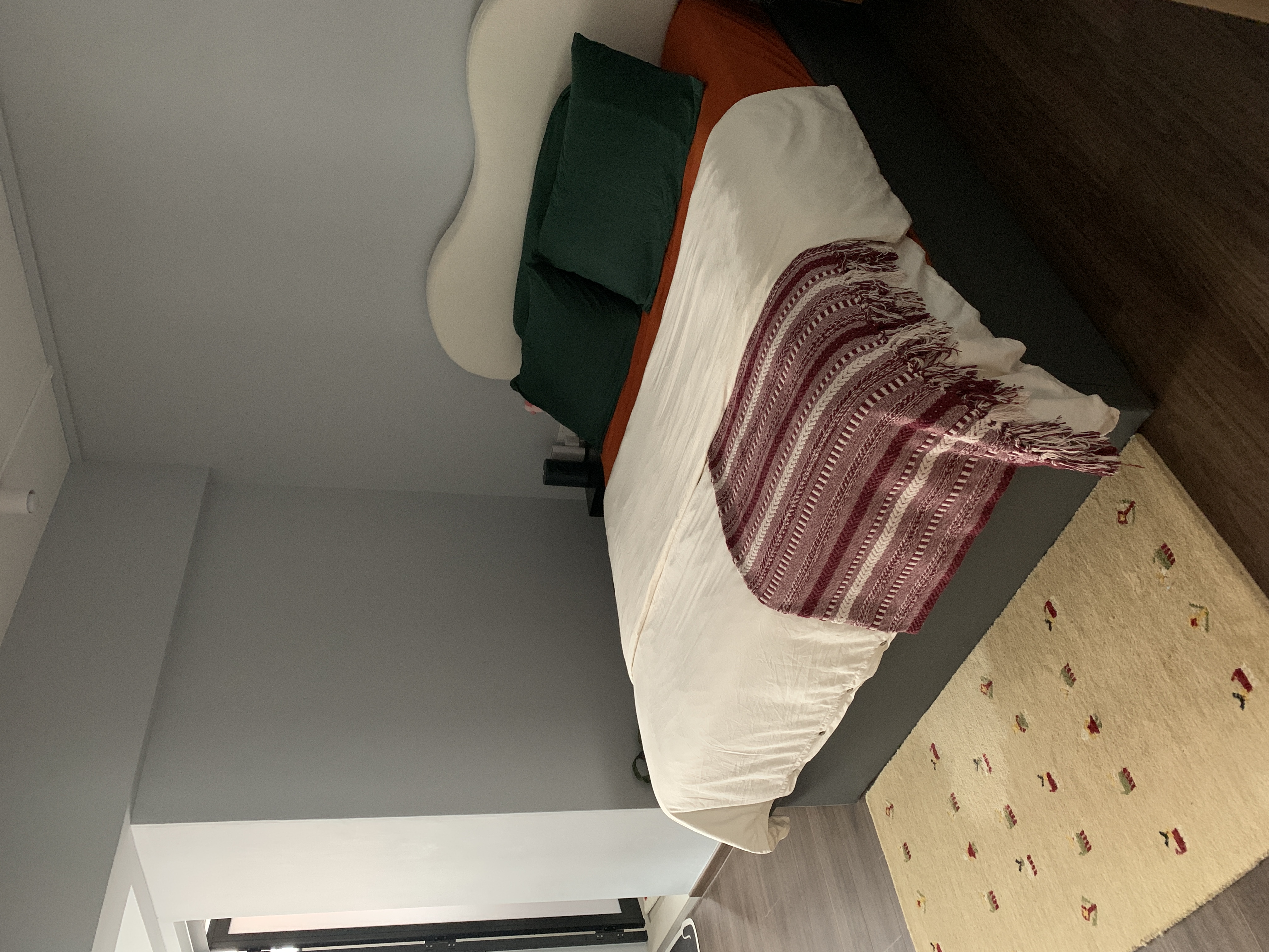 A maximalist Christmas set-up with DIY touches! - modern bedroom, cozy bed, white comforter, green pillow, orange pillow