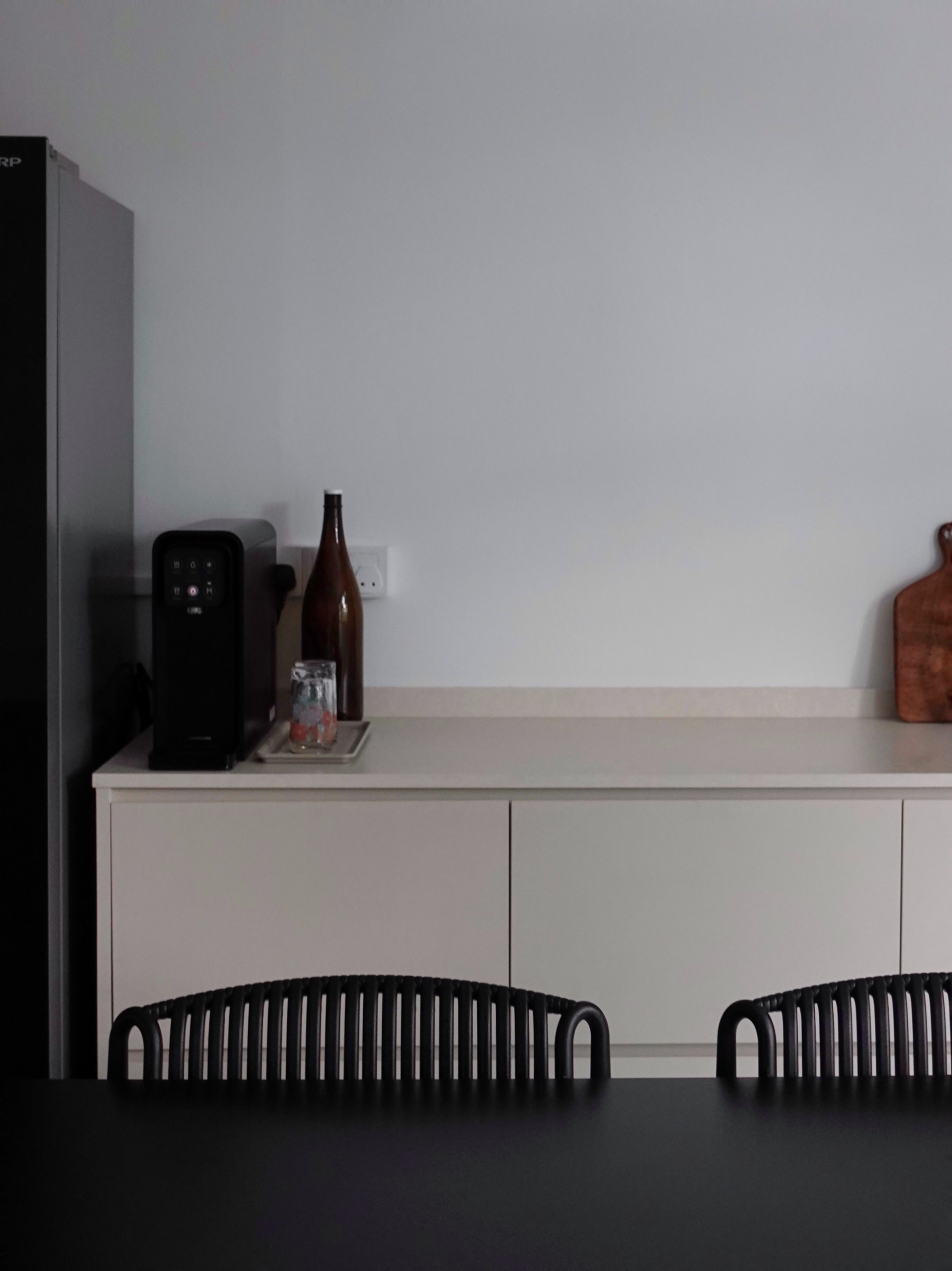 How we kept our dining room visually clutter-free - Modern kitchen countertop, minimalist design, sleek appliances, black and