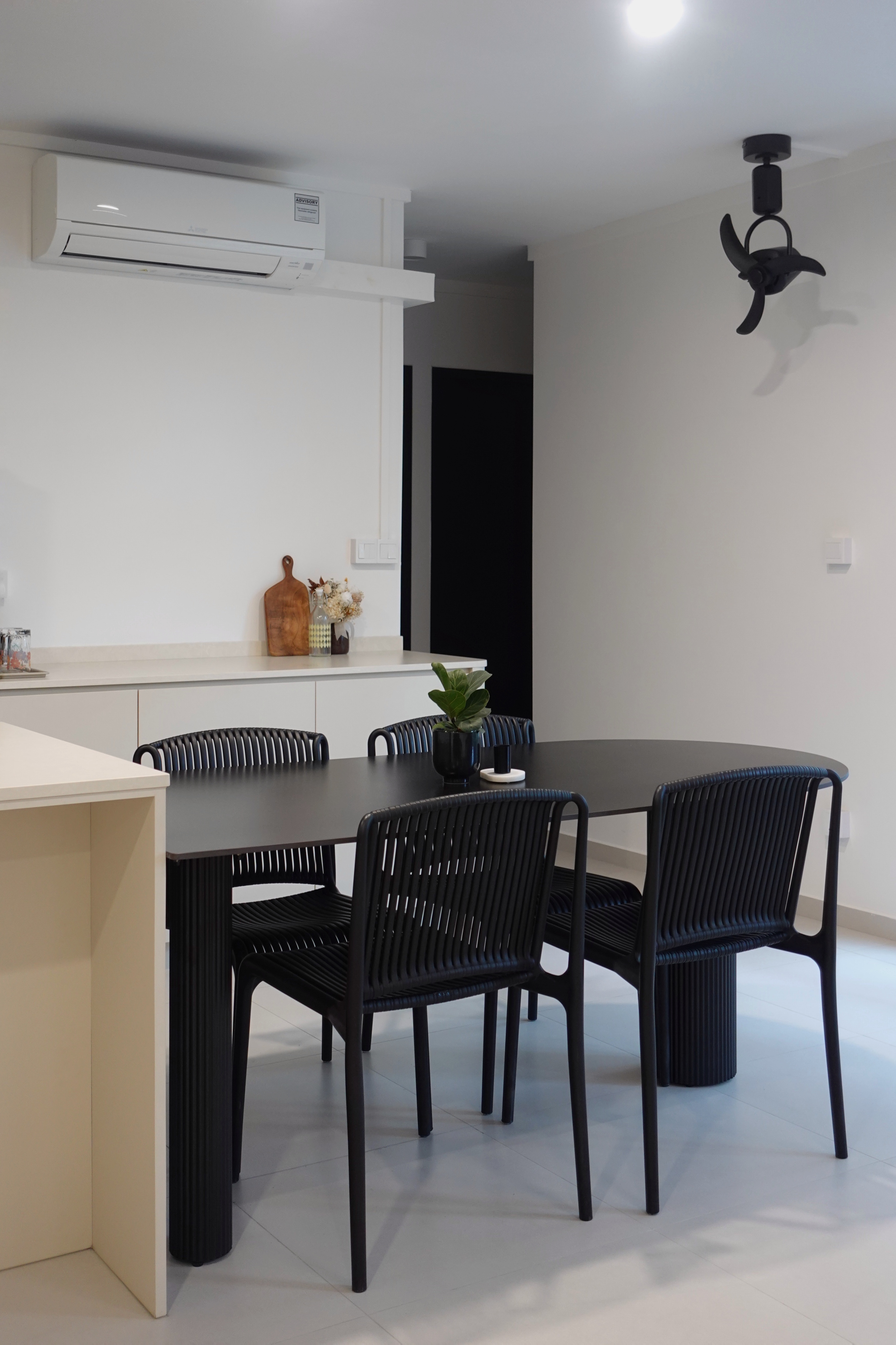 How we kept our dining room visually clutter-free - Modern dining room with sleek black chairs, minimalist kitchen counter