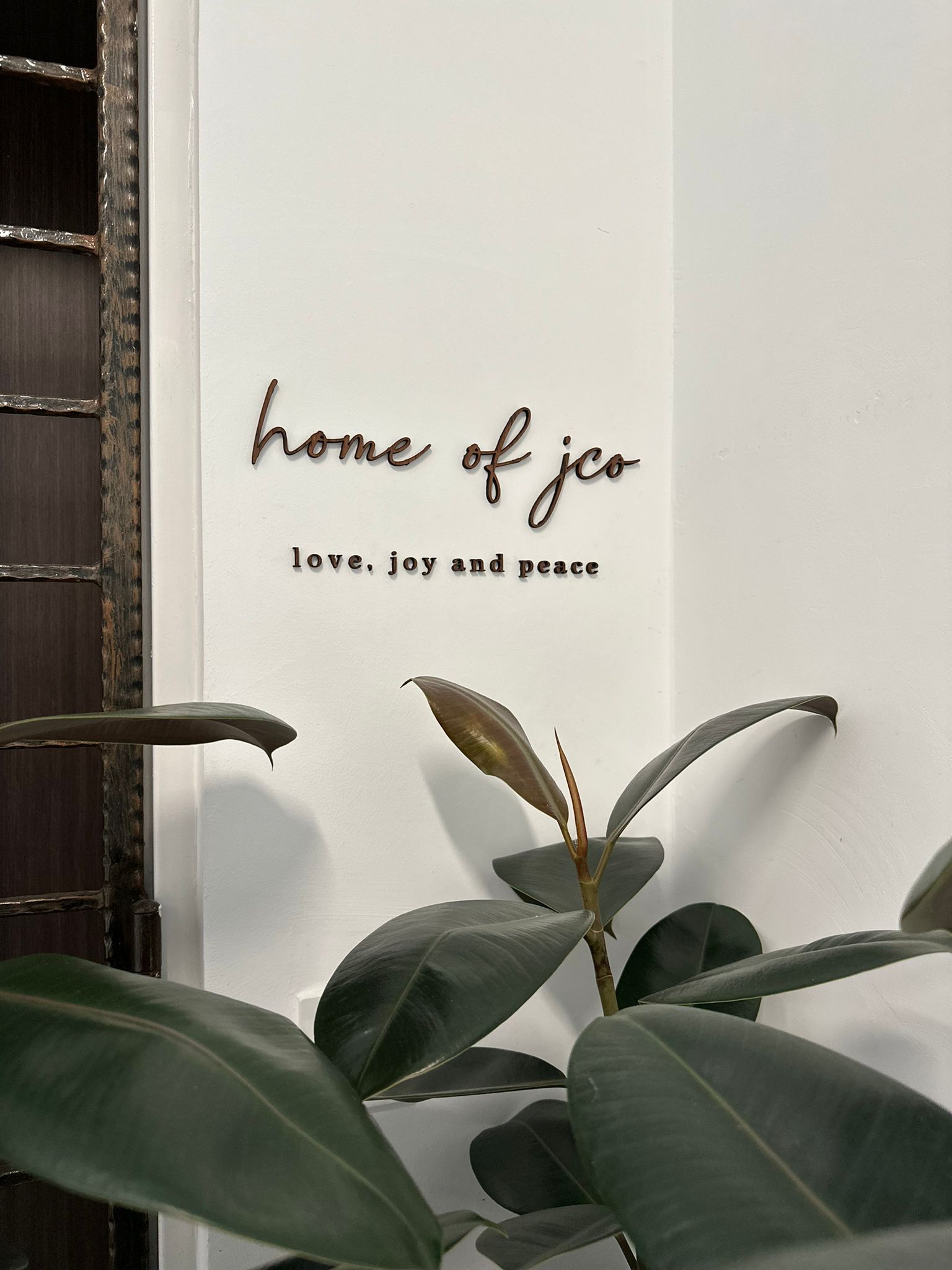 Welcome to our home - be greeted from our minimalist entryway - "Home of JCO", "Love, Joy and Peace", "Cursive Font"