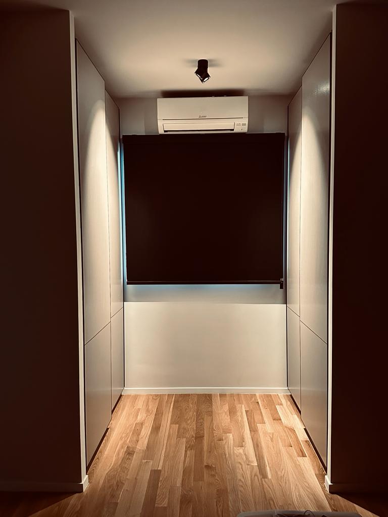 Simple and fuss free bedroom - Modern minimalist hallway, sleek white air conditioning unit, wooden floor, dark wall