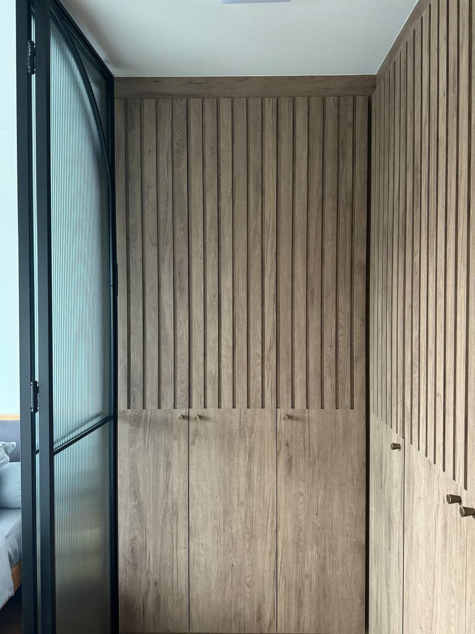 Reimagining Relaxation: Our Home Staycay - Wooden panel wall, vertical slats, natural wood texture, minimalist design, modern