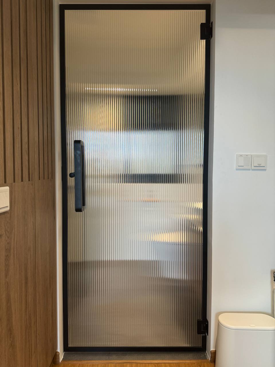 Reimagining Relaxation: Our Home Staycay - Wooden panel, modern design, vertical blinds, minimalist decor, sleek door, black