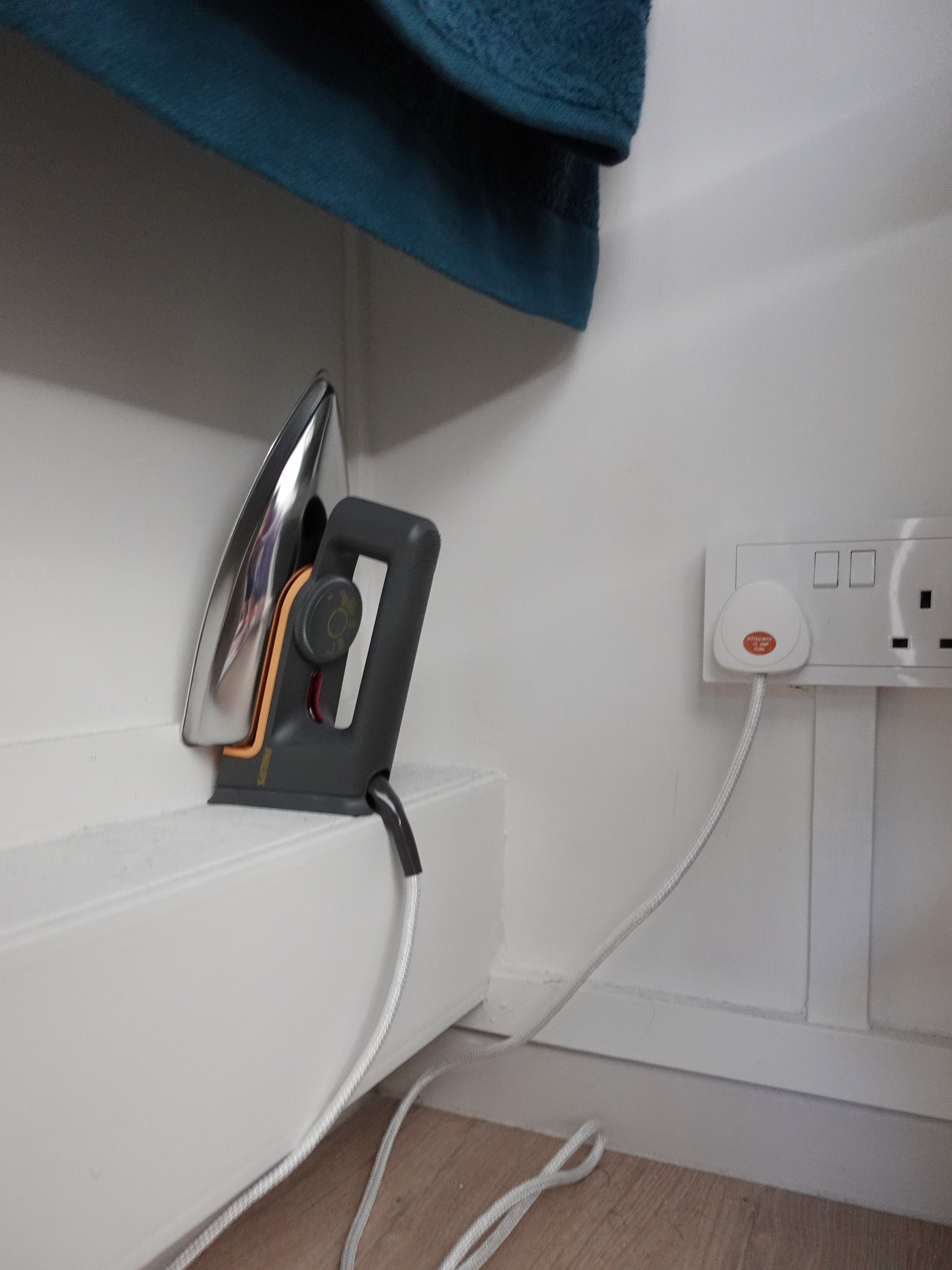 A minimal bedroom with a wardrobe that you’ve never seen before - electric iron, white shelf, wall-mounted iron, towel rack