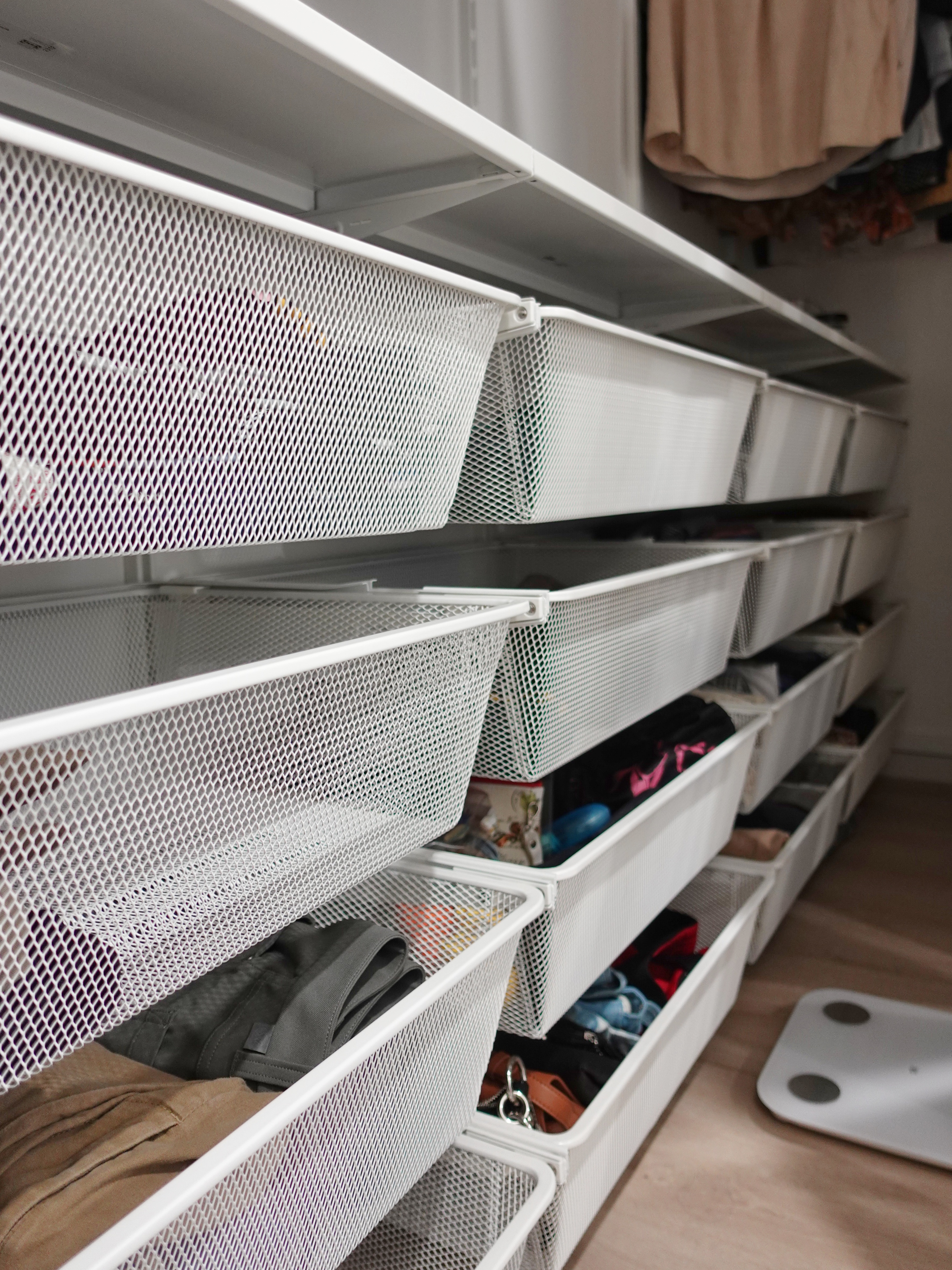 A minimal bedroom with a wardrobe that you’ve never seen before - Organized closet with mesh organizers, neatly arranged