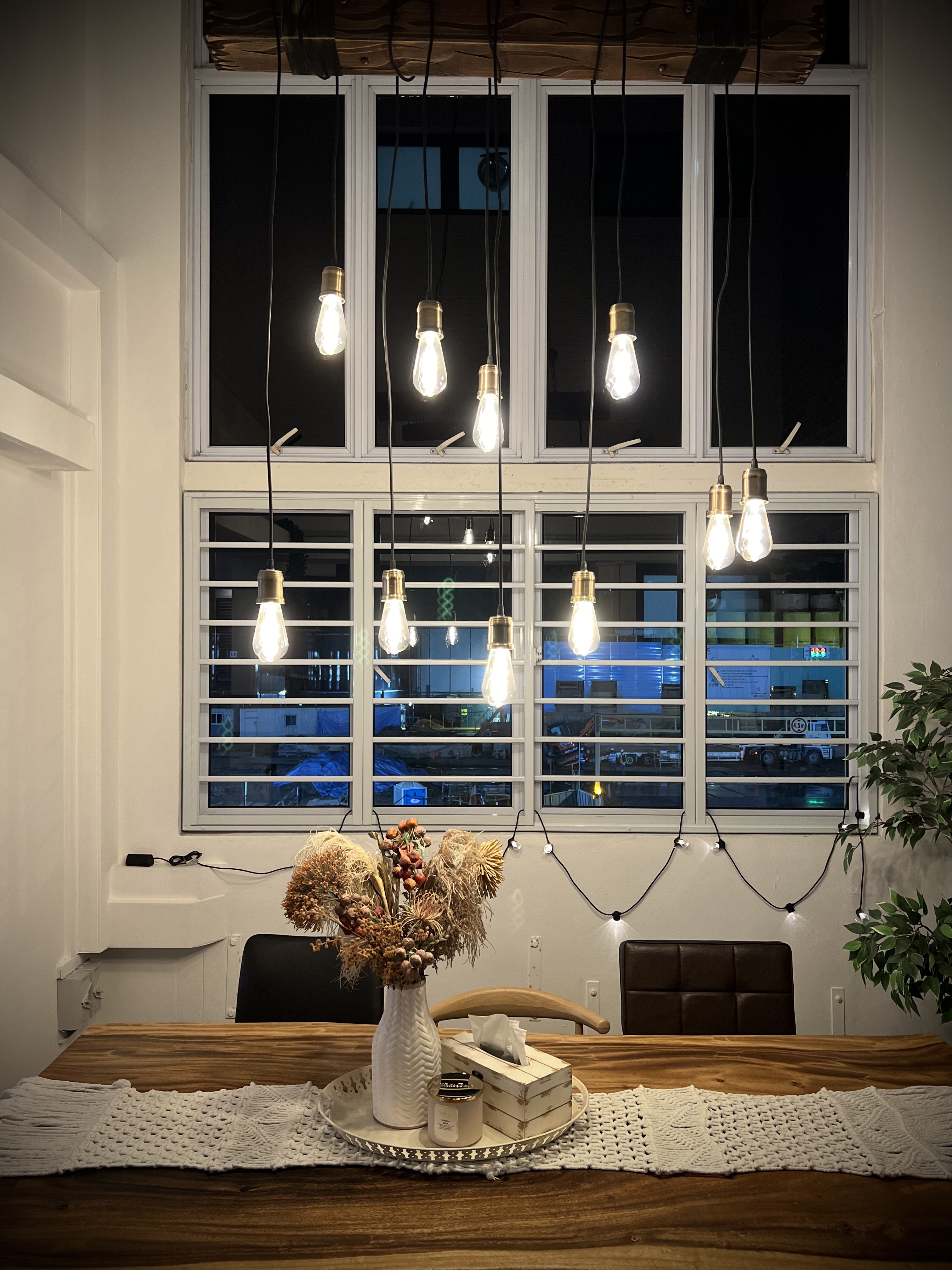 Dining Space: More than just meals - modern dining room, cozy ambiance, rustic decor, hanging light bulbs, white walls