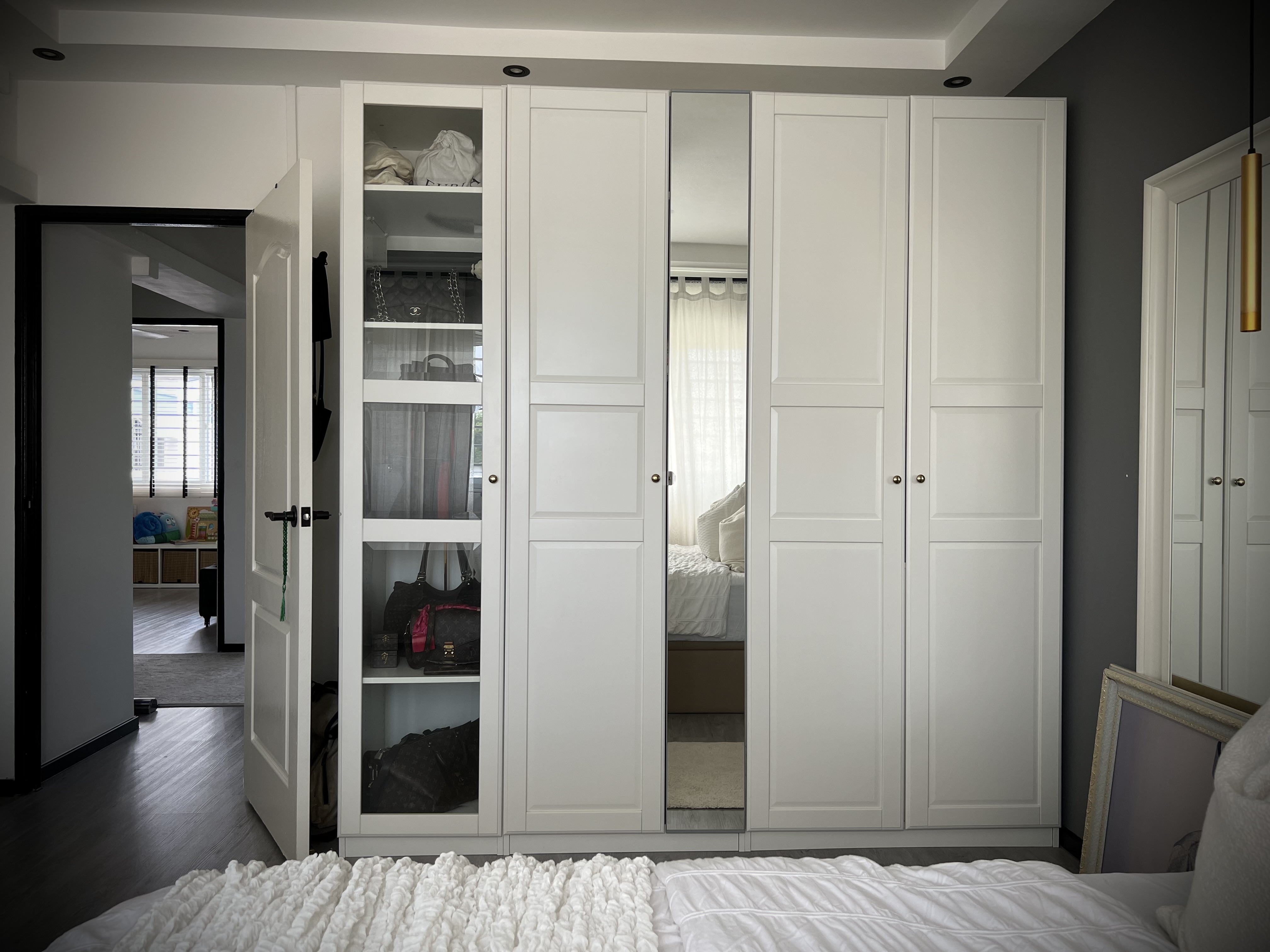 Bedroom: White, Gold and Grey Colour Scheme - White wardrobe with glass doors, neatly organized closet, modern interior