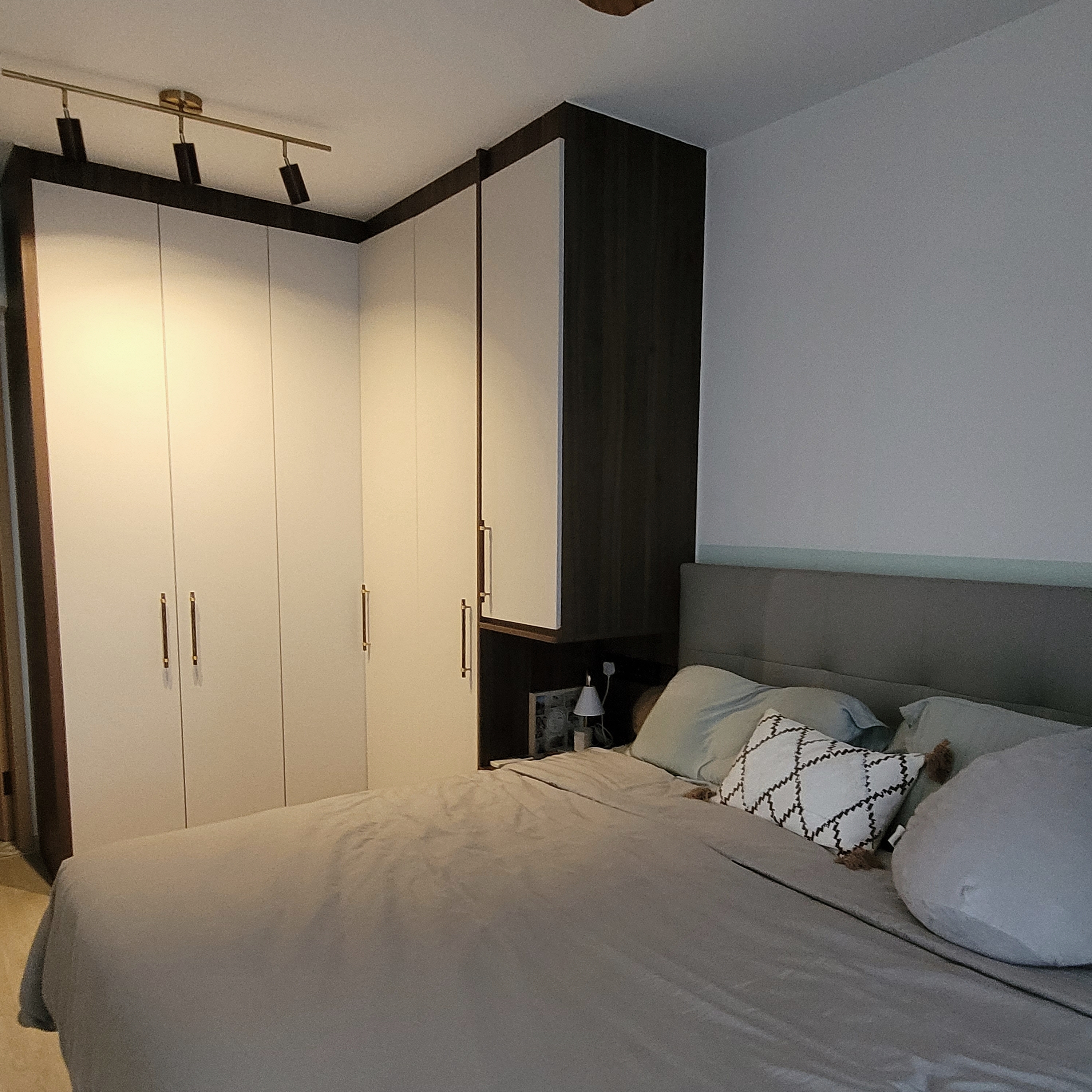 Our serene, cozy, and functional master bedroom - White wardrobe with gold handles, beige bed with gray bedding, decorative