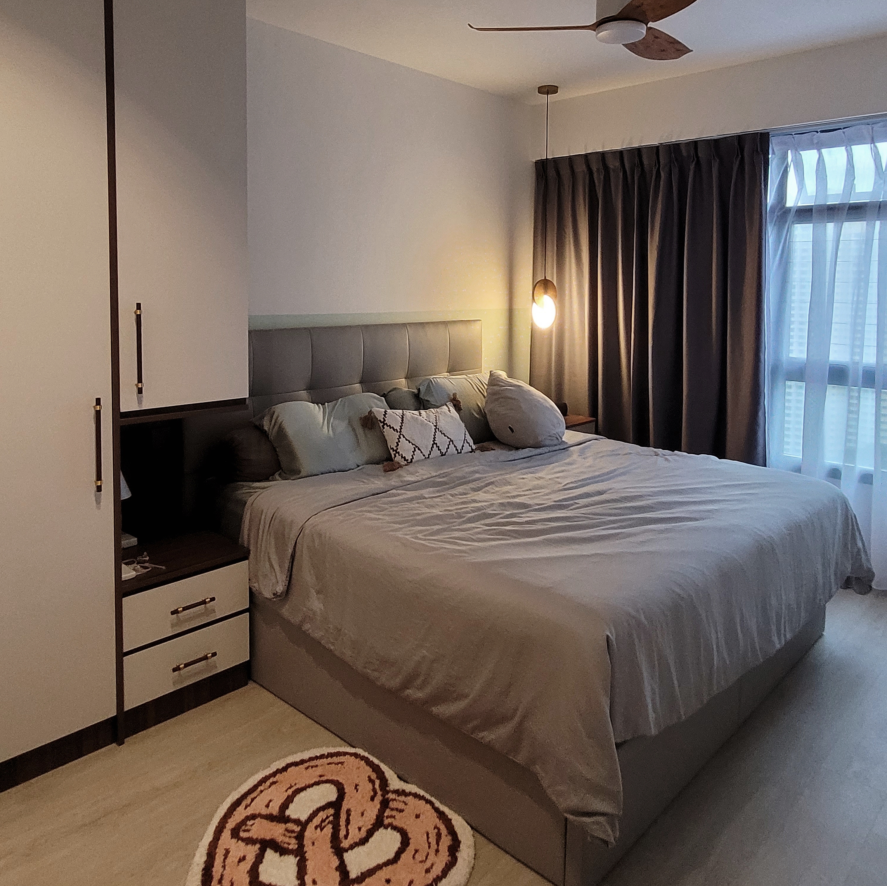 Our serene, cozy, and functional master bedroom - Bedroom with neatly made bed, gray headboard, light-colored bedding