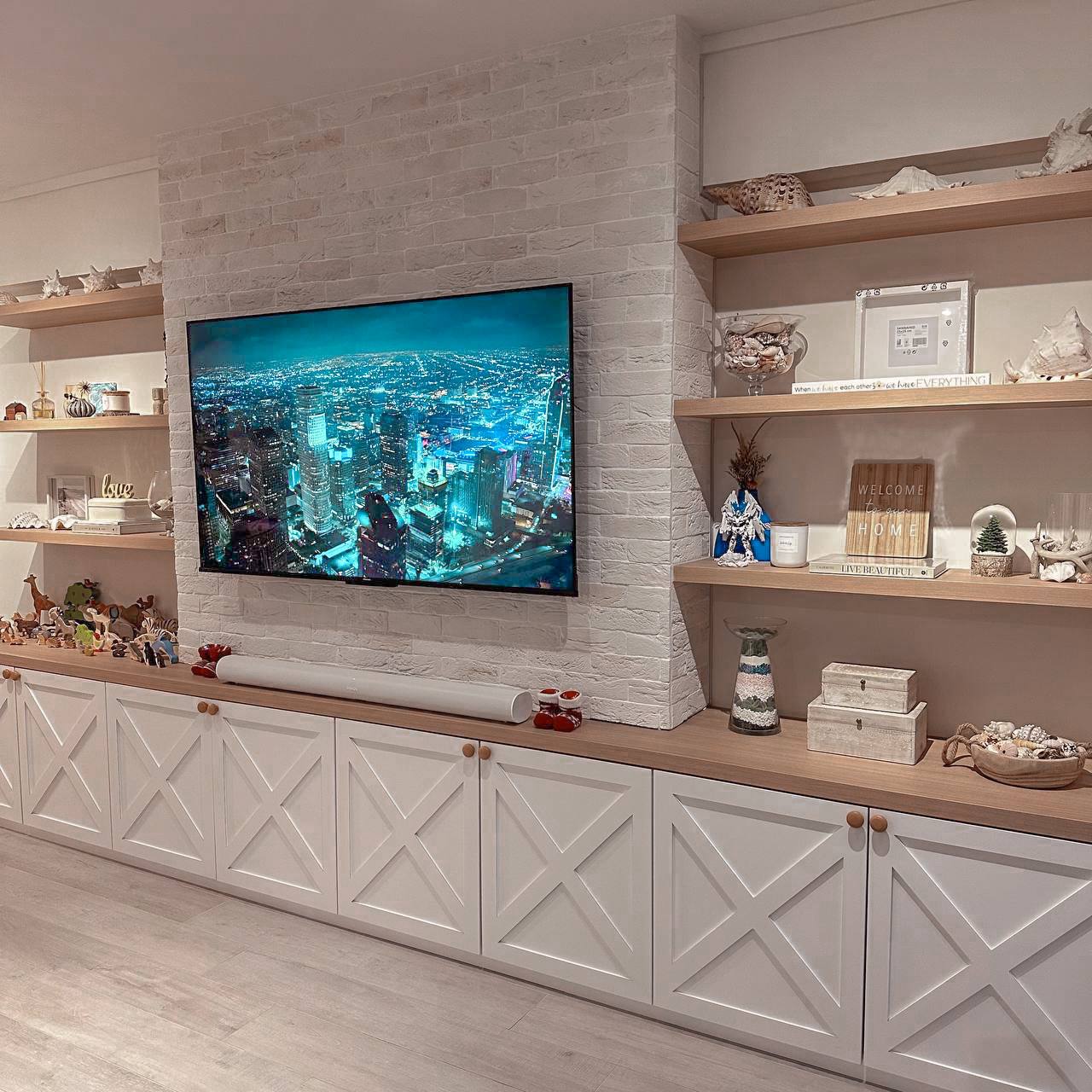 Farmhouse Living Room with Brick Walls! - Modern living room with sleek white brick wall and wooden shelves, Contemporary