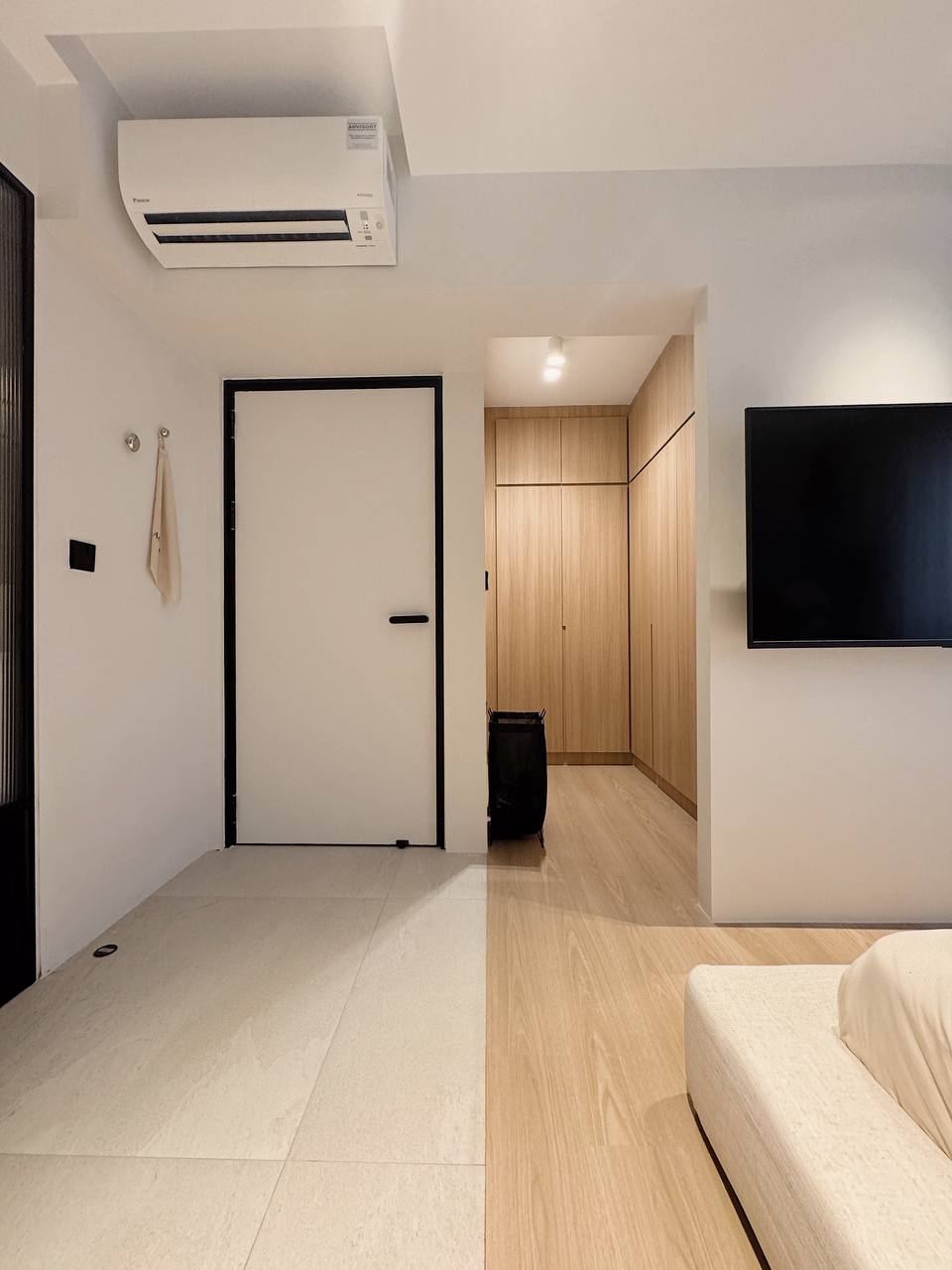Our 'Hotel' inspired Bedroom like Everyday Retreat - Minimalist living room with sleek white door, black frame, and modern