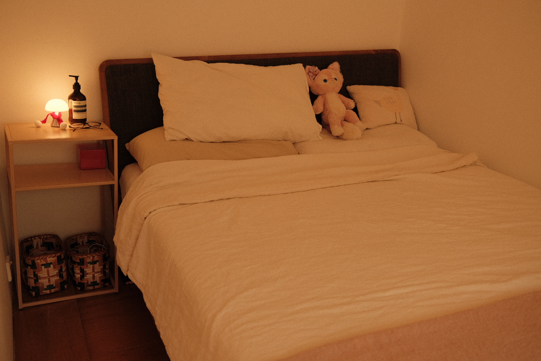 Our compact bedroom layout and accessories  - bedside bedside table, cozy bedroom, soft lighting, plush toy, white pillows